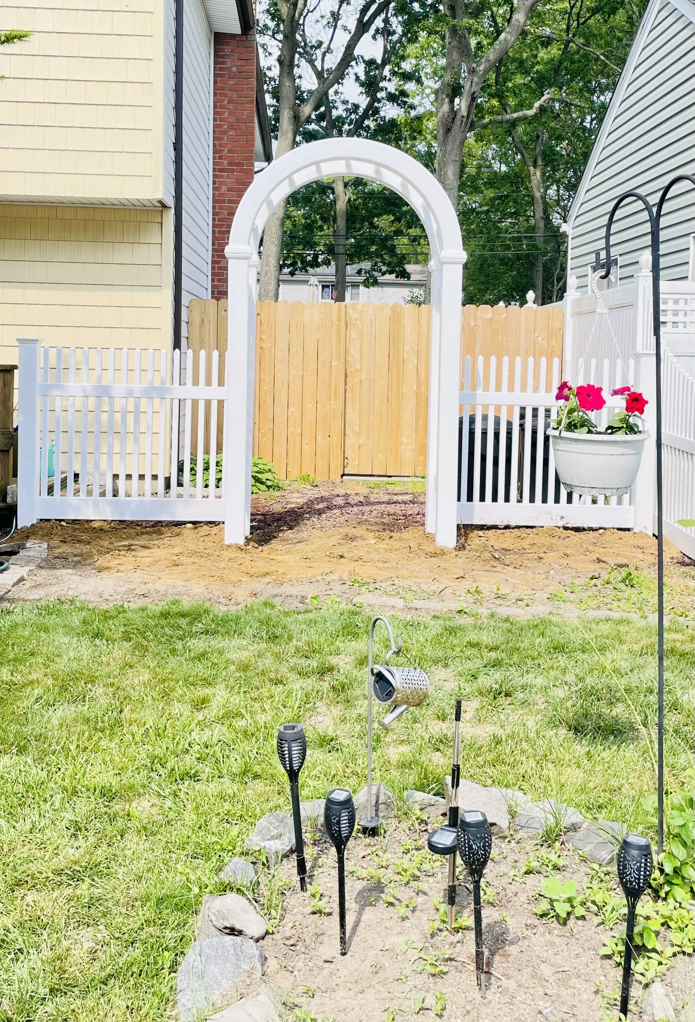 white vinyl picket fence with an arbor (1).jpeg