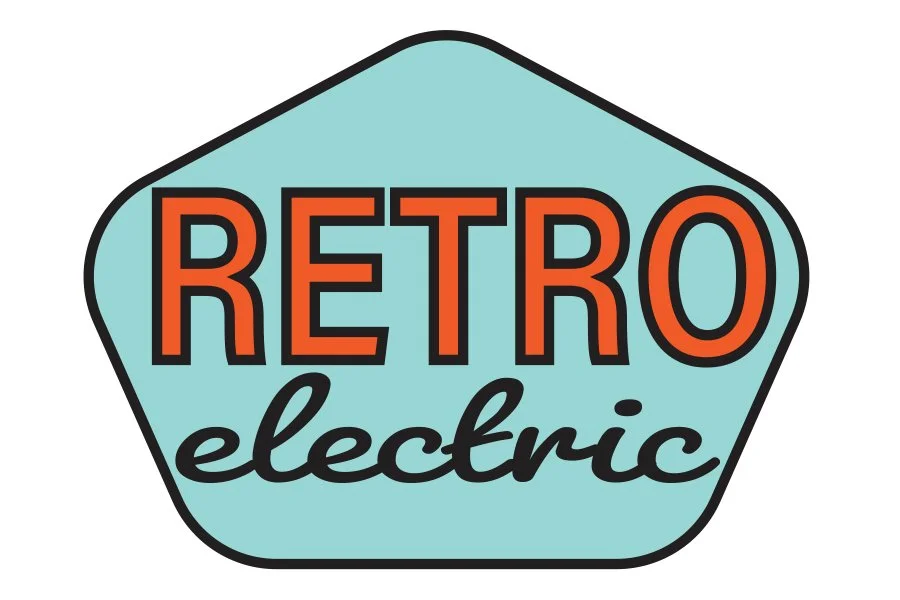 Logo with the words 'RETRO electric' in stylized font inside a hexagonal shape, with 'RETRO' in orange outlined letters and 'electric' in black cursive on a light blue background.
