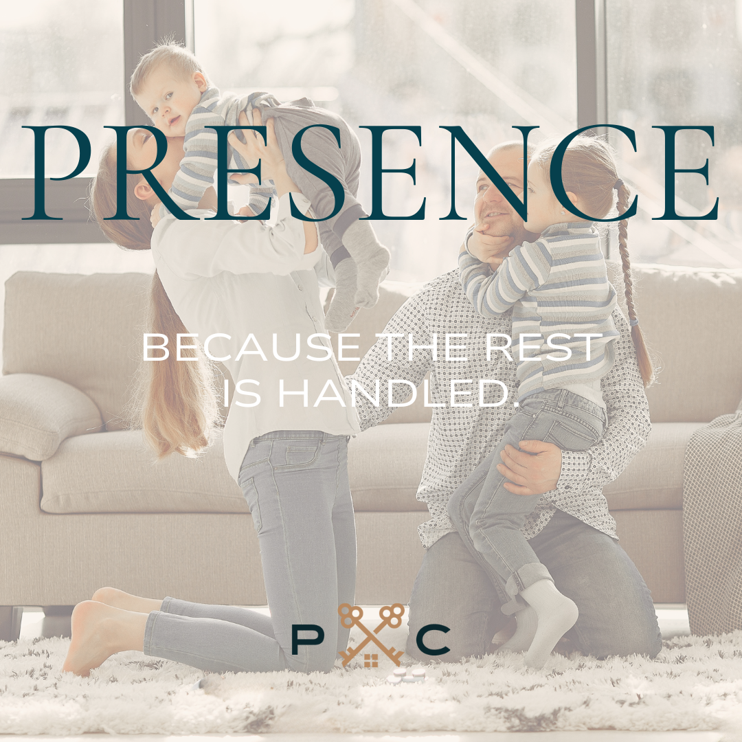 Parents enjoying time with their children on the living room floor in a well organized, light filled home in Raleigh, NC.