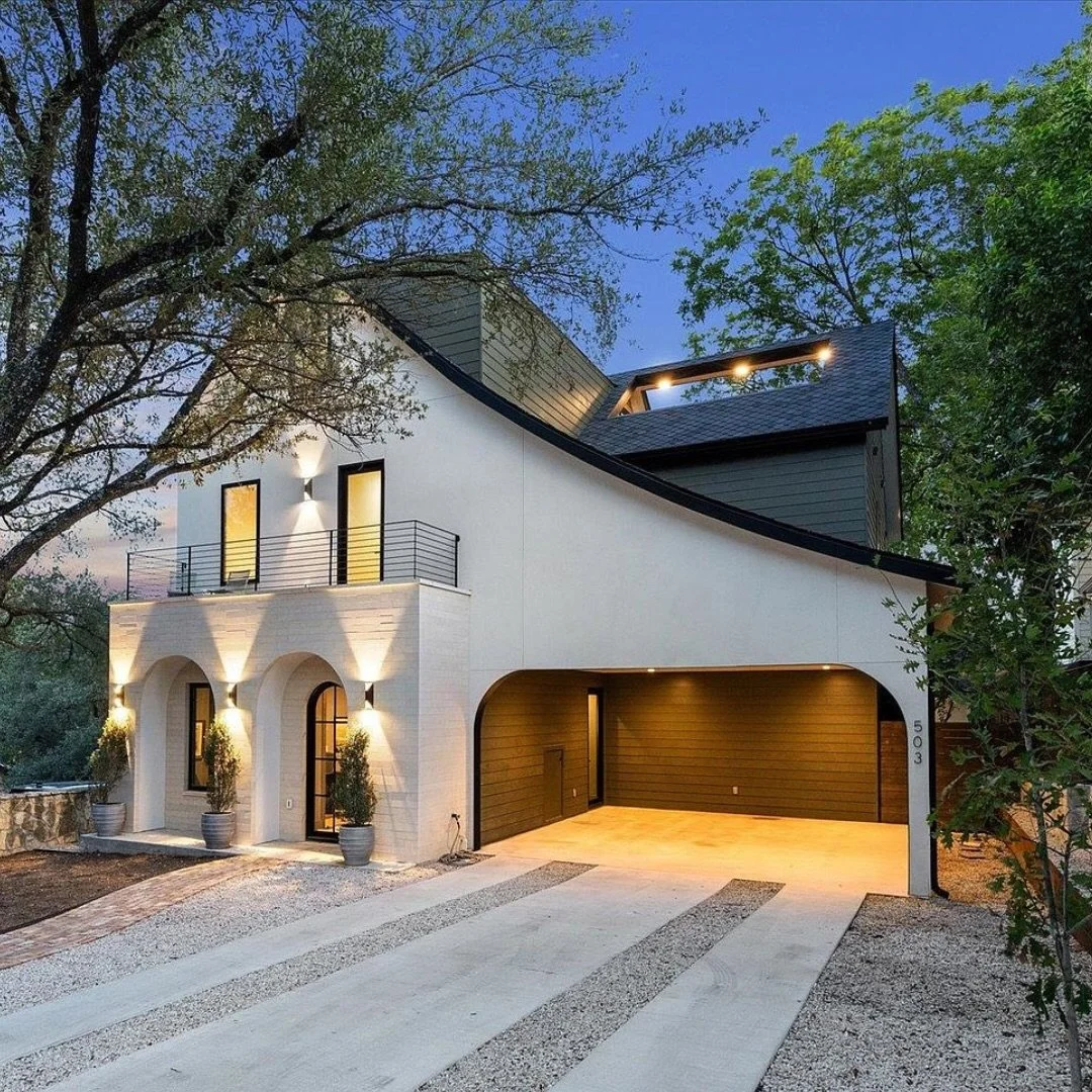Terrace Residence is a contemporary reinterpretation of a classic Tudor design with a new main house and restored 1928 guest house in Travis Heights. The home combines traditional architectural character with contemporary detailing through the use of