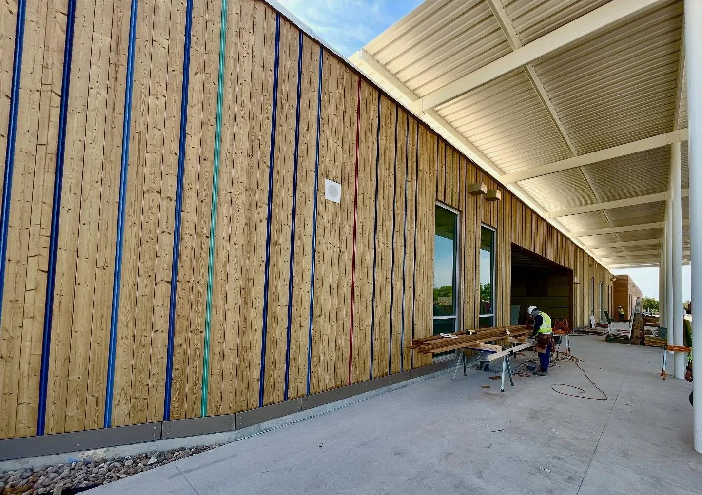Siding crew knocking out an install of 16&rsquo; boards of @thermorydesign Kodiak for a new elementary school.
