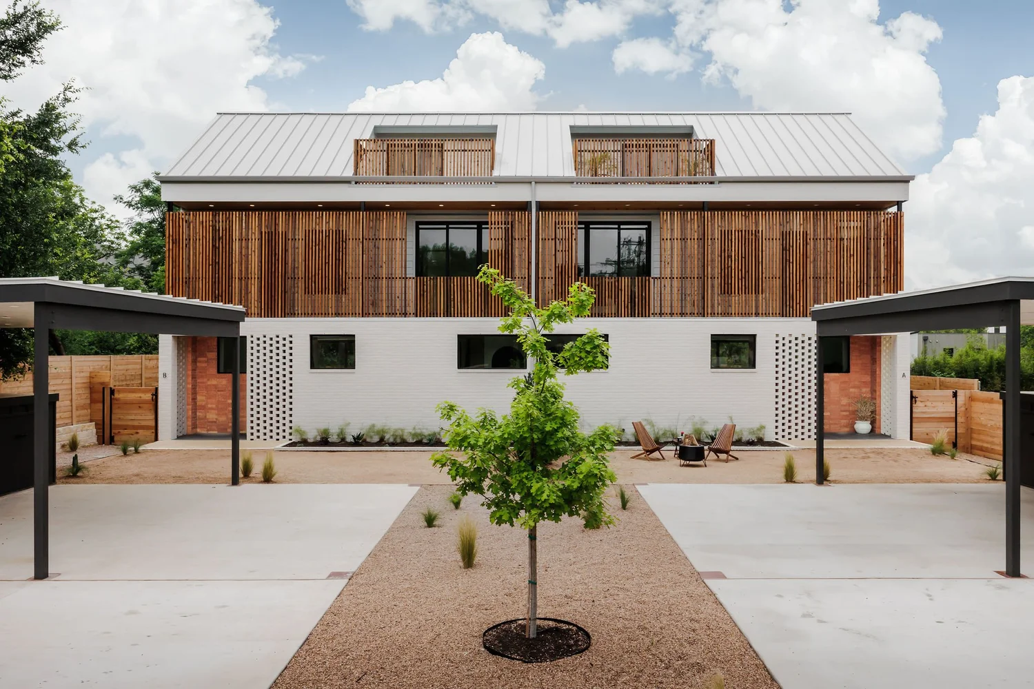 Elizabeth Street residence by Forsite Studio — wood-clad exterior with metal roof, courtyard entry, and shaded outdoor seating — Austin, TX