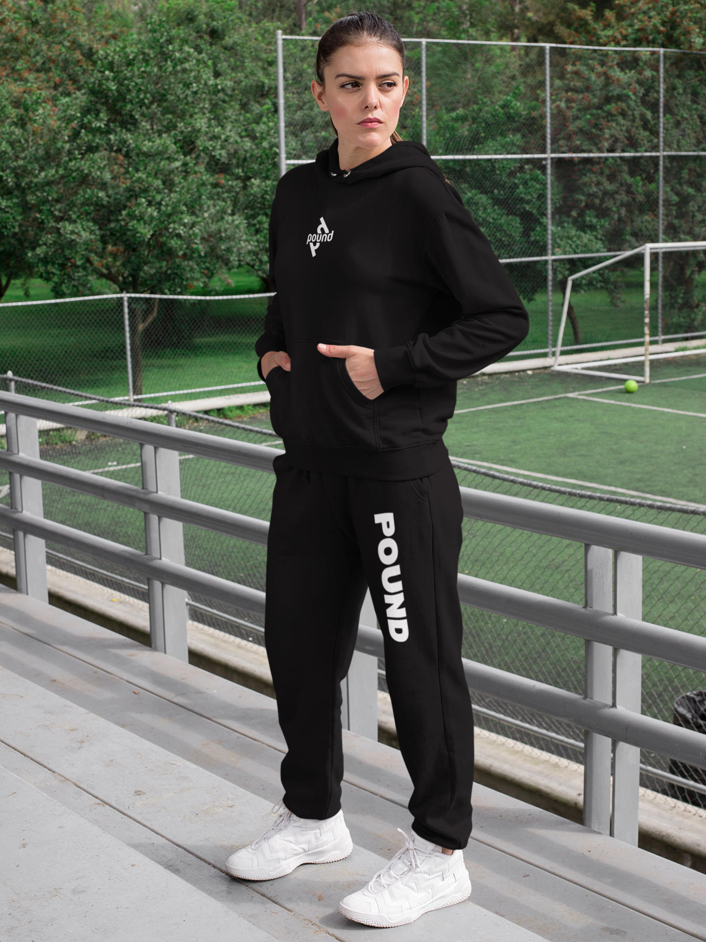 sublimated-sweatpants-mockup-of-a-woman-with-a-hoodie-by-a-mini-soccer-field-29865.png