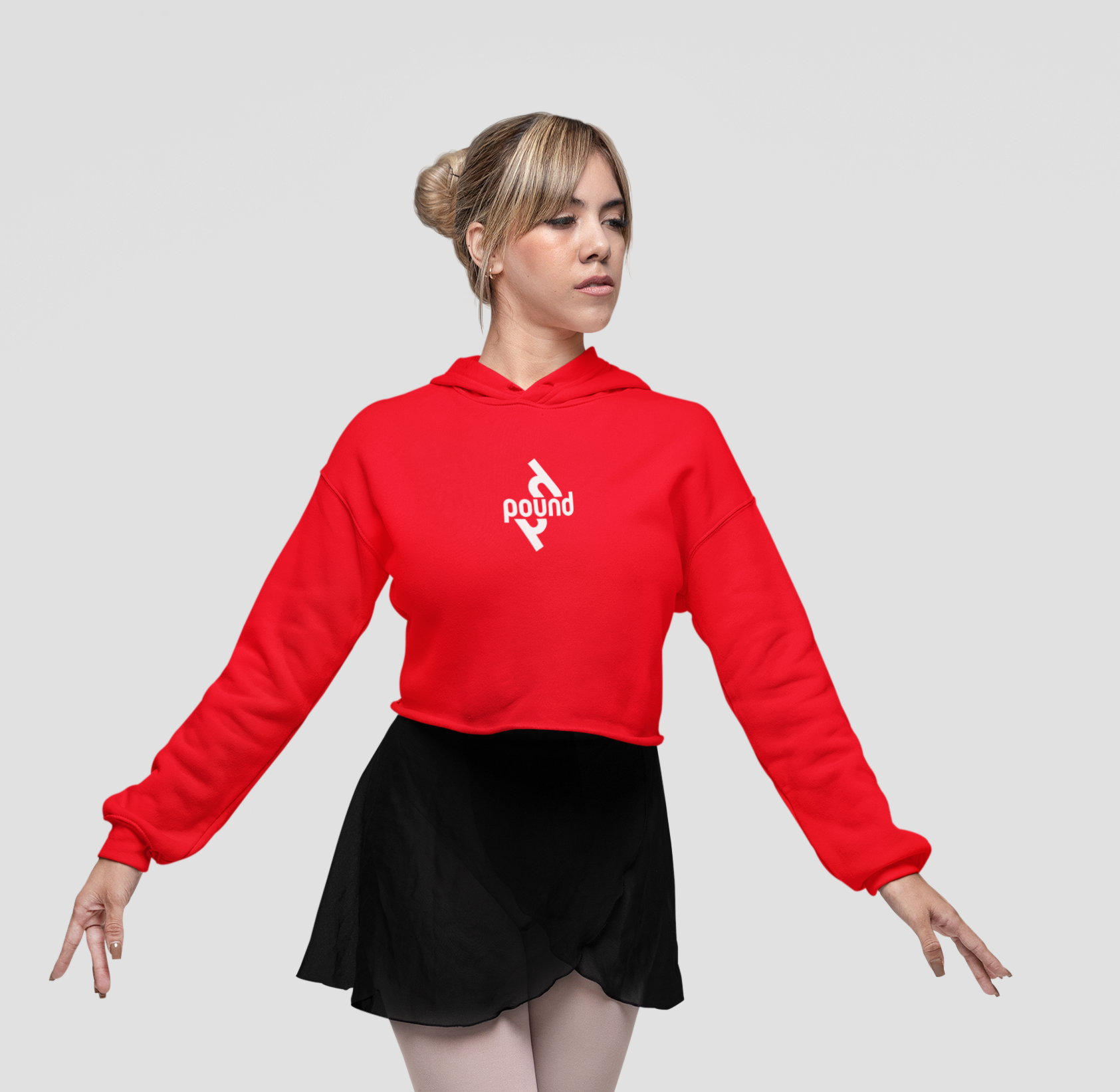 Crop Top Hoodie by POUND,. Women wearing red hooded sweatshirt with white Pound logo. size small.