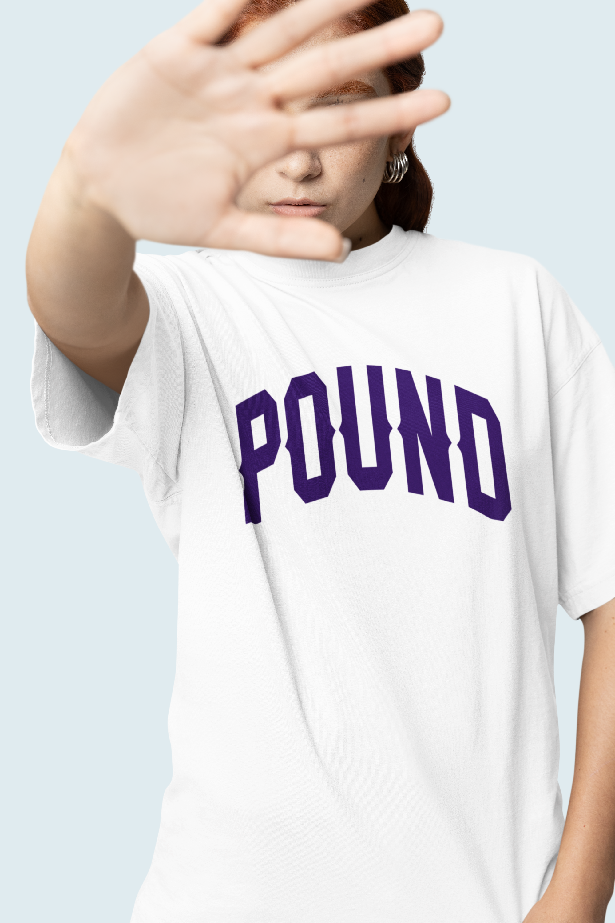 A woman wearing an oversized heavyweight cotton tee. Made by Pound Navy Blue high infused print is crisp and fashion on a high-end level, Los Angeles Designed and assembled.