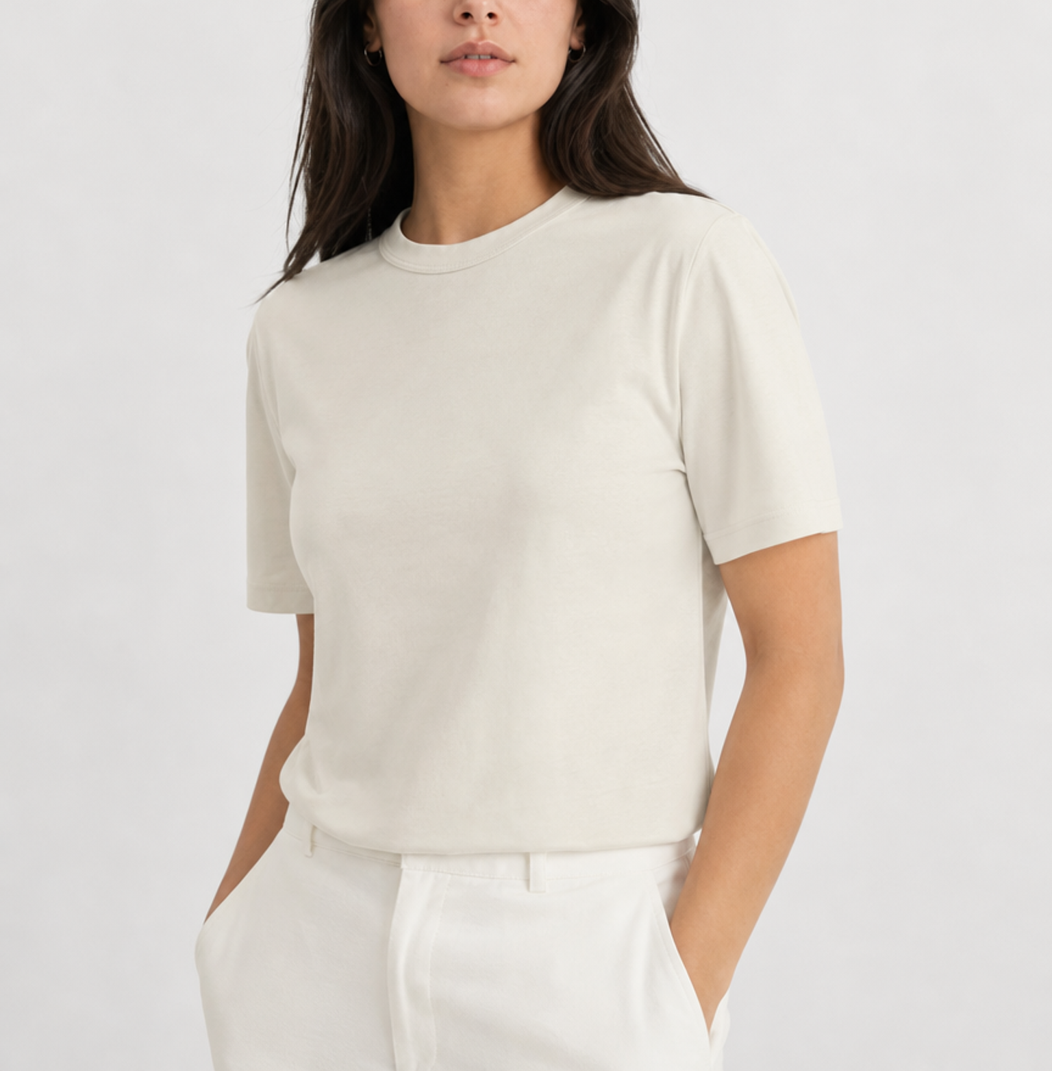 Woman wearing a T-shirt. Off-white collection. Bone-colored T-shirt made from mid weight ring-spun 100% cotton.