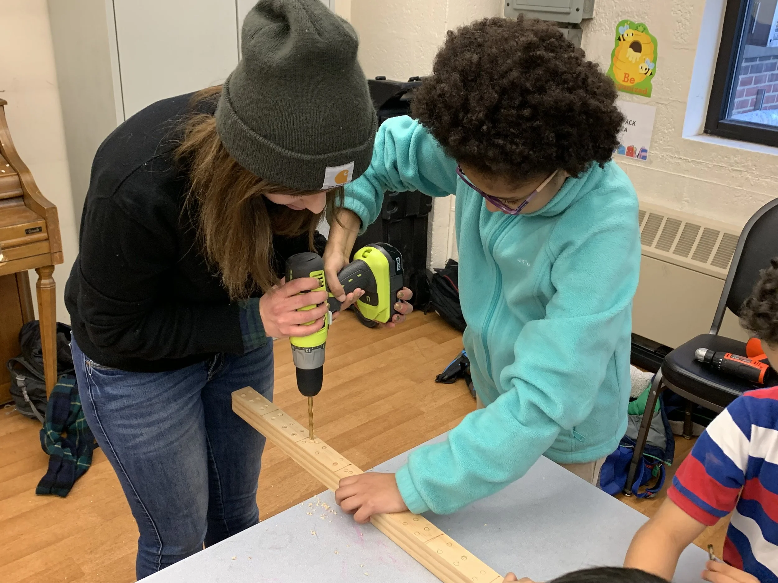 LE building_carpentry 2019 teacher helping kid drill(1).jpeg