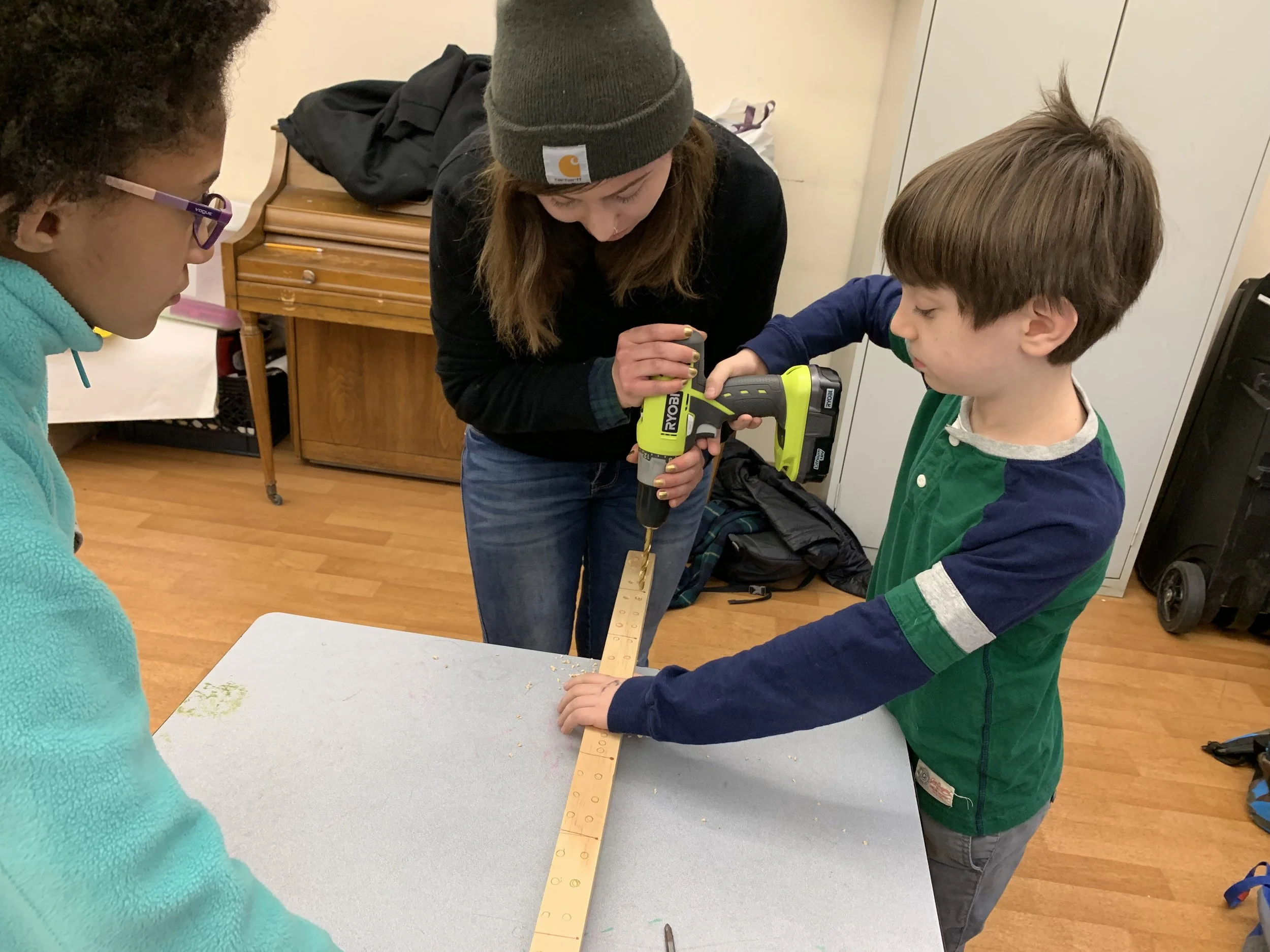 LE building_carpentry 2019 teacher helping kid drill.jpeg