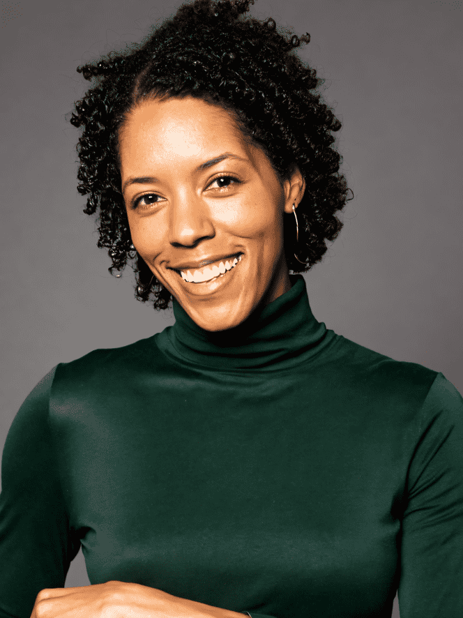 Portrait smiling woman, Chloe Brooks professional home organizer, with short curly hair.