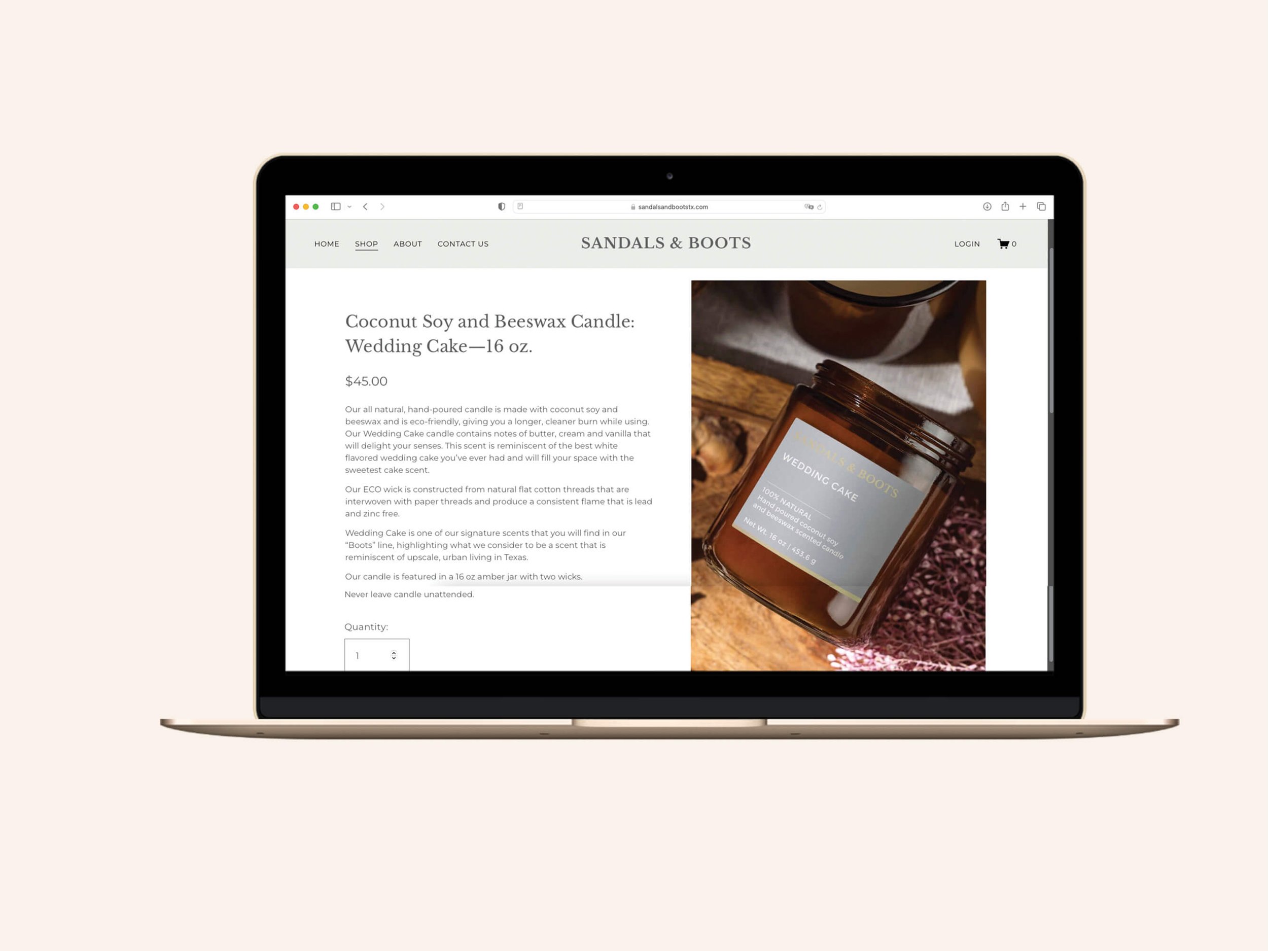 Screenshot of the Sandals & Boots product detail page displayed on a gold MacBook laptop, showing the listing for a 16 oz. Wedding Cake coconut soy and beeswax candle with product description, pricing, and an amber jar product photo.