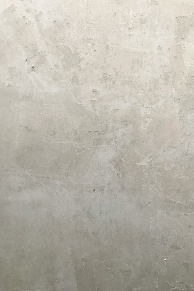 Close-up of a textured, light gray wall with a slightly rough surface.