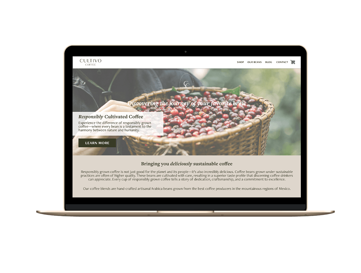Laptop screen displaying a coffee website with a basket of coffee cherries in the background image.