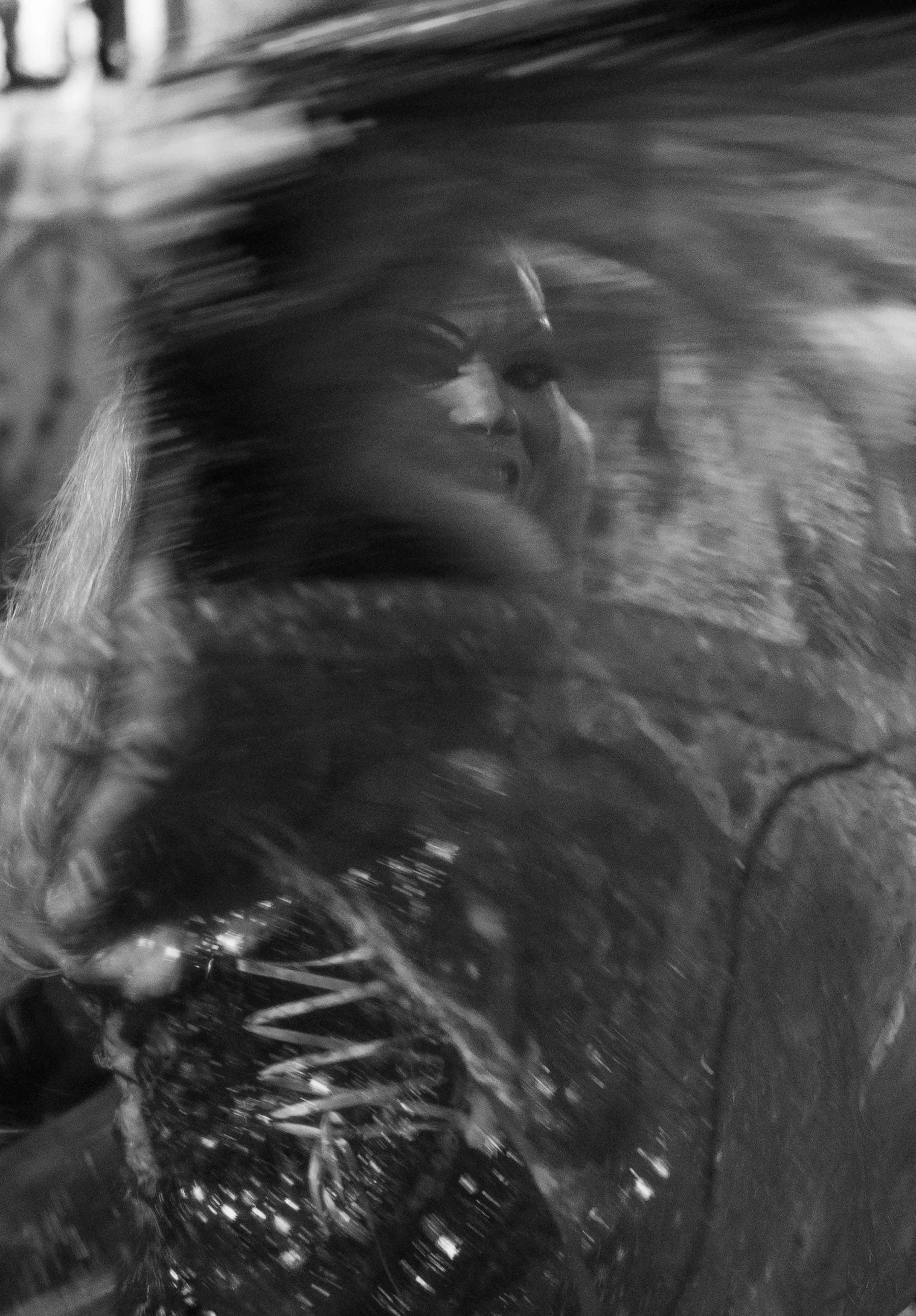 Nick twirls his dress and sings to the audience. 