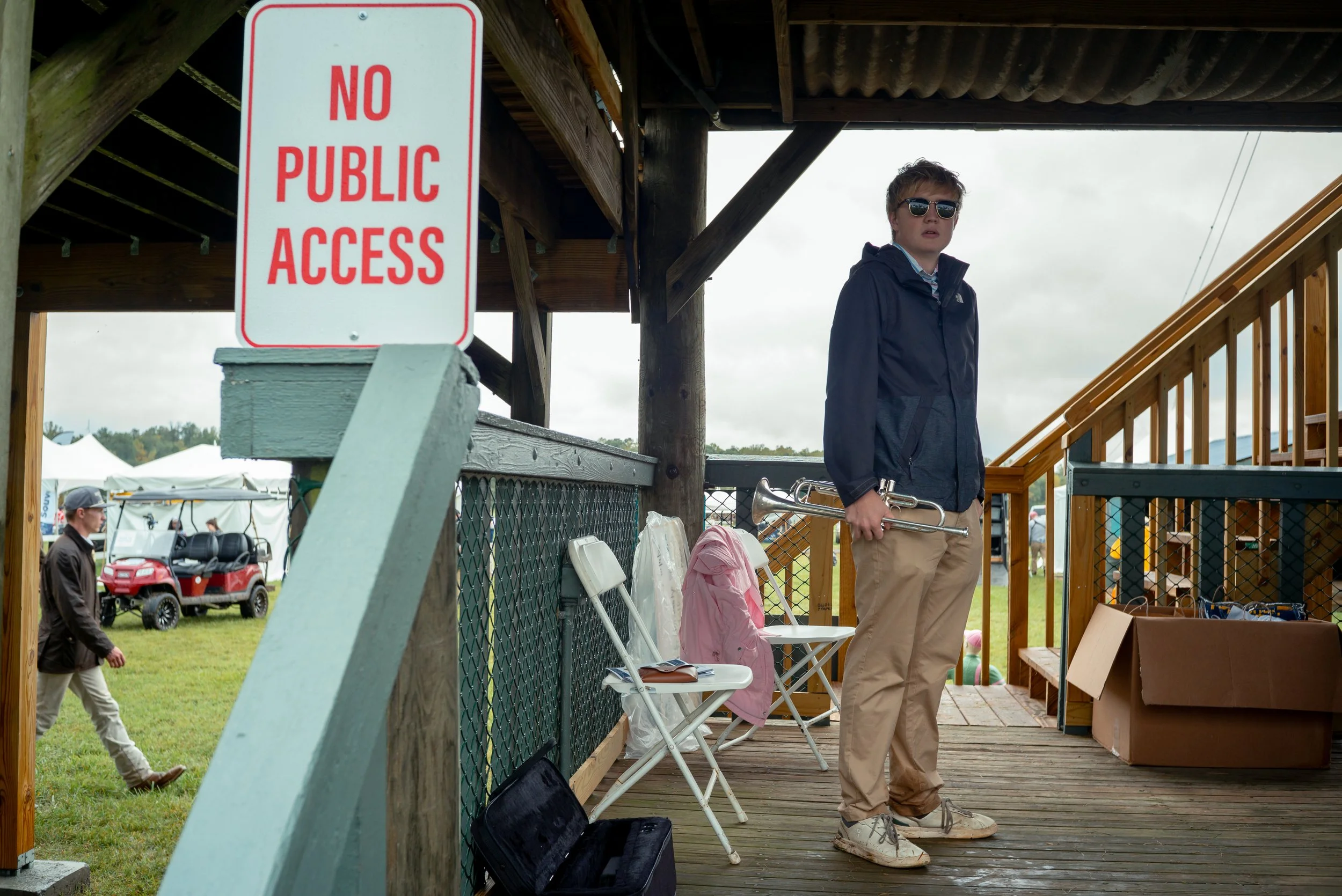 A bugler sounds a call signaling jockeys to make their way to the starting line before a race at the Foxfield Fall Races.
