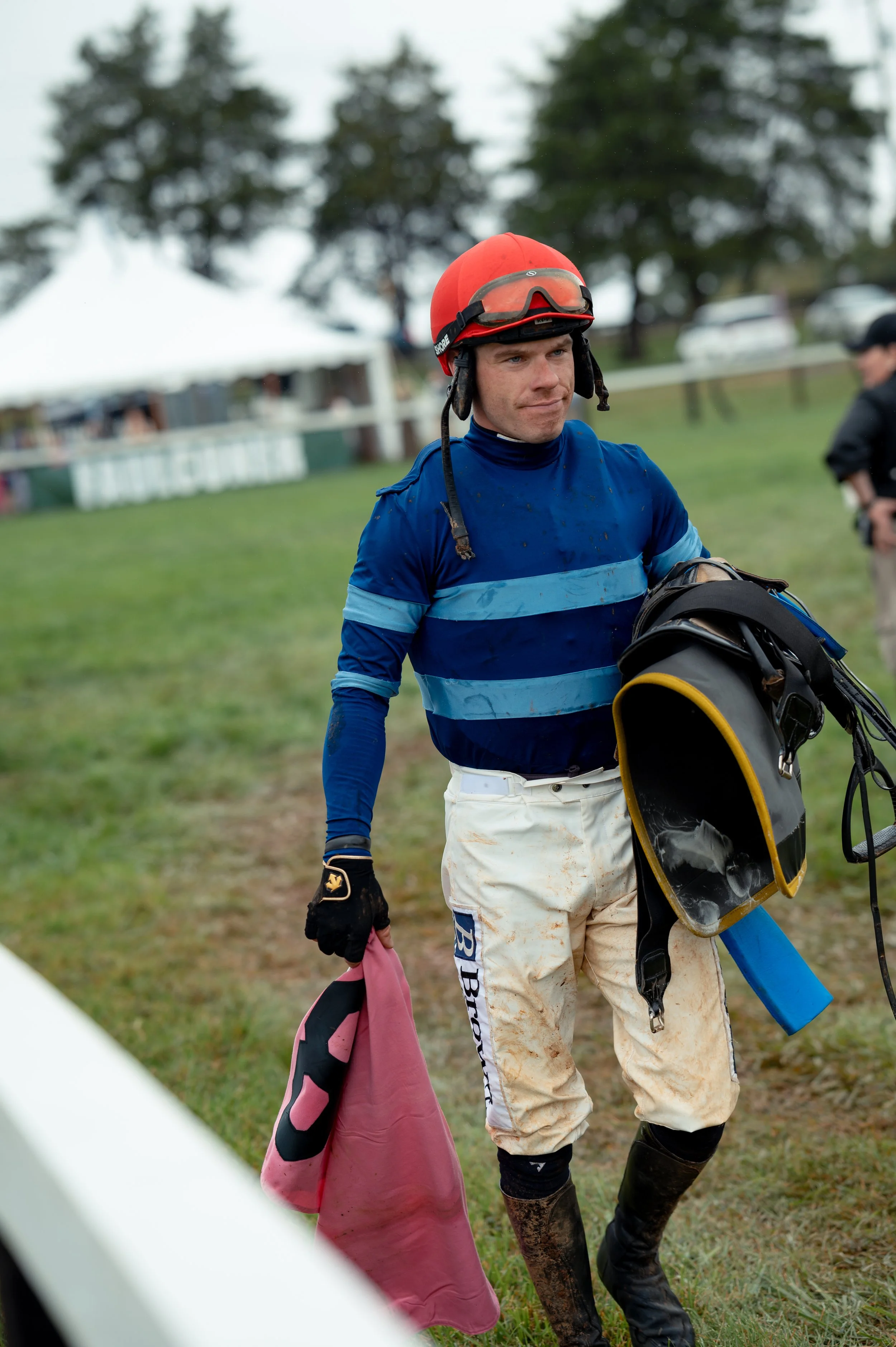 A jockey riding horse No. 8 removes his saddle and walks back to the tent after completing the second race of the Foxfield Fall Races on Sunday, Oct. 4, 2026, in Albemarle County, Va.