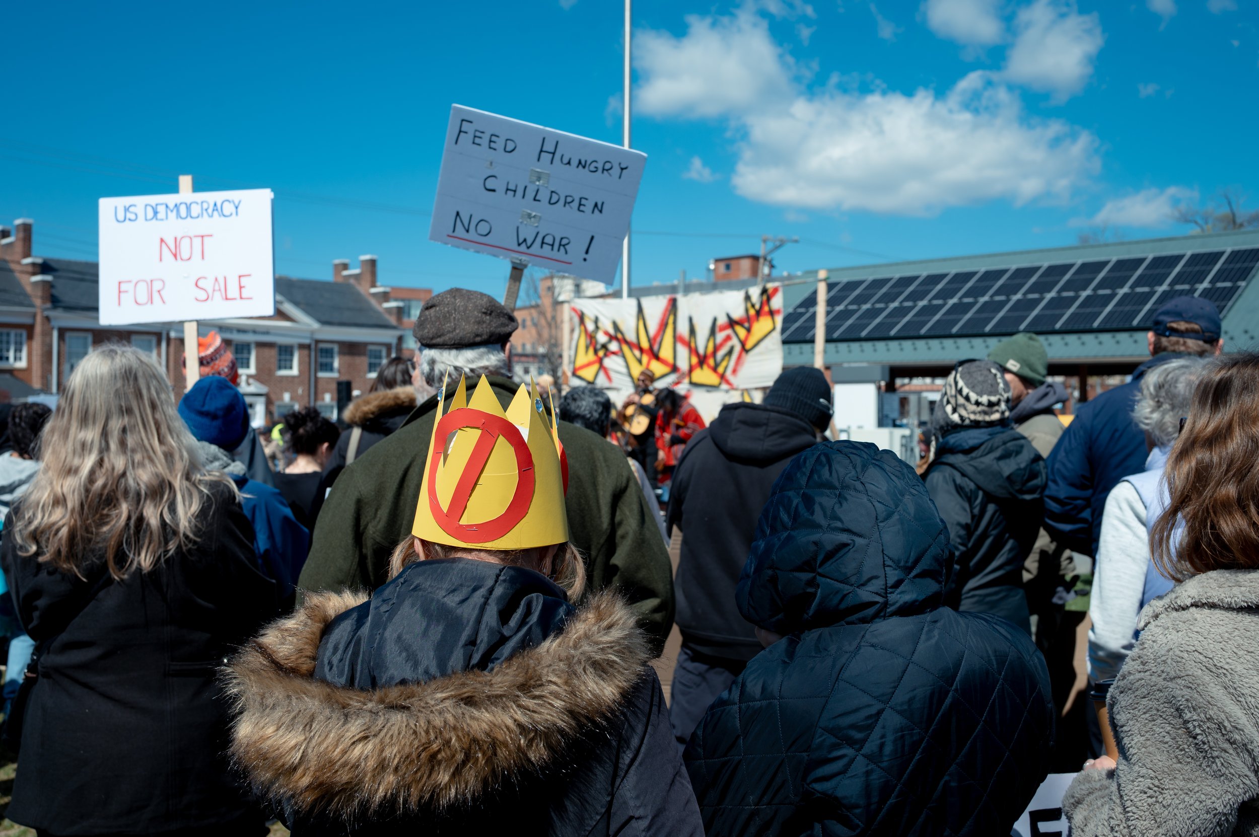 Many protesters wear crowns with large crosses on them.