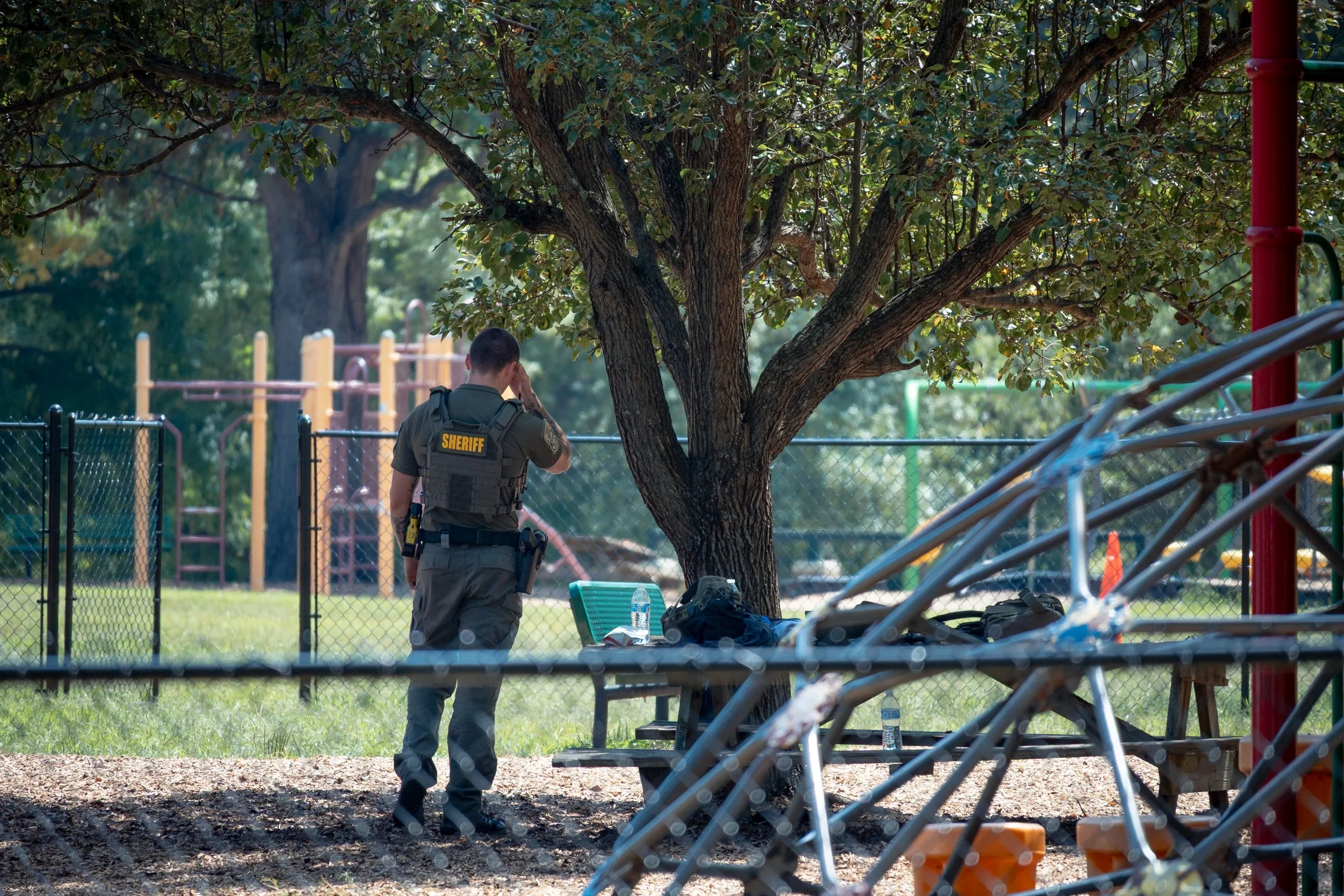 An Augusta County sheriff wipes tears from his face as children gather on a playground during a family reunification following a shooting at Westwood Hills Elementary School in Waynesboro, Virginia, on September 2, 2026. A staff member was wounded in