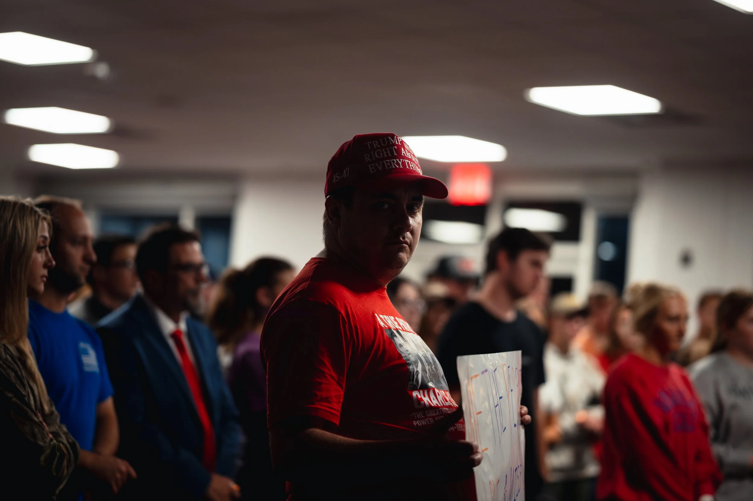 A man wearing a “Trump Was Right About Everything” hat speaks to attendees during a vigil for Charlie Kirk. Gathered inside the venue, attendees listened as he reflected on Kirk’s legacy and influence. September 20th, 2026.