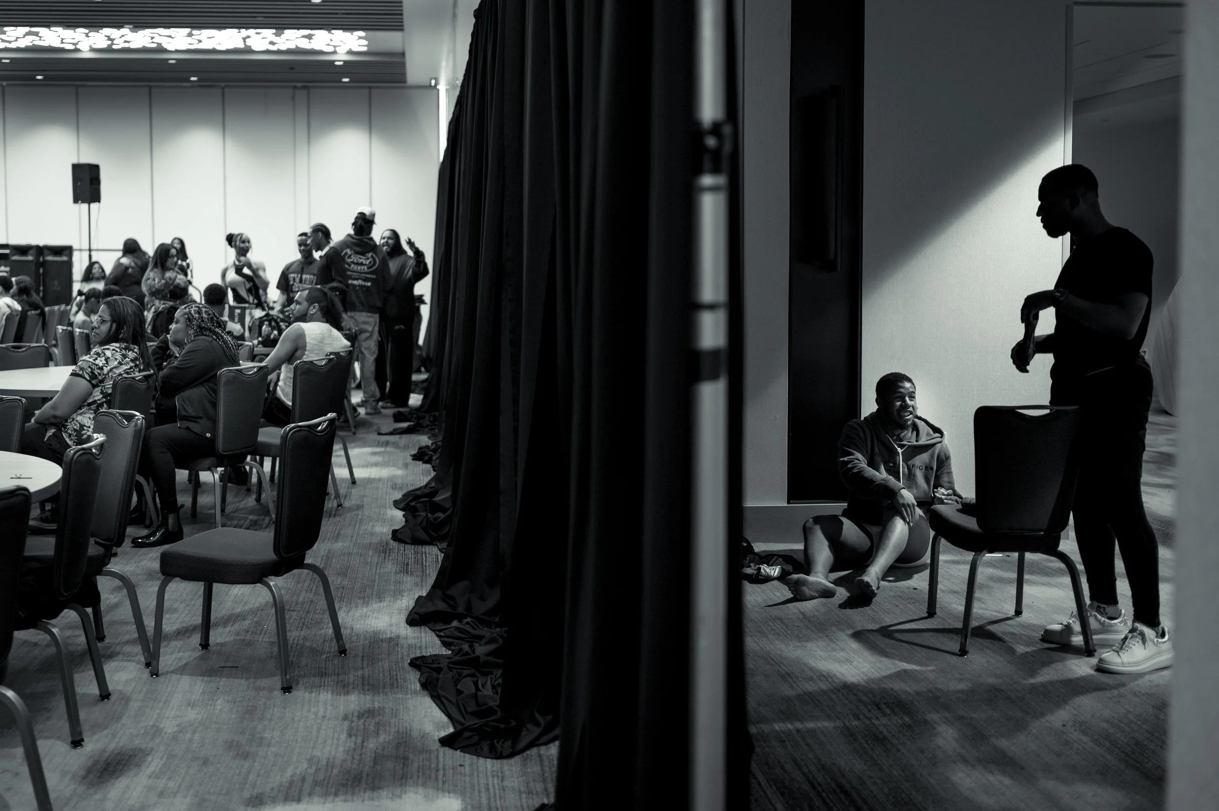 Performers prepare behind a curtain before the Mr. and Miss Black Pride Ball in Washington, D.C. Makeup, costumes and garment bags filled the backstage area as contestants and performers made final preparations ahead of the event.