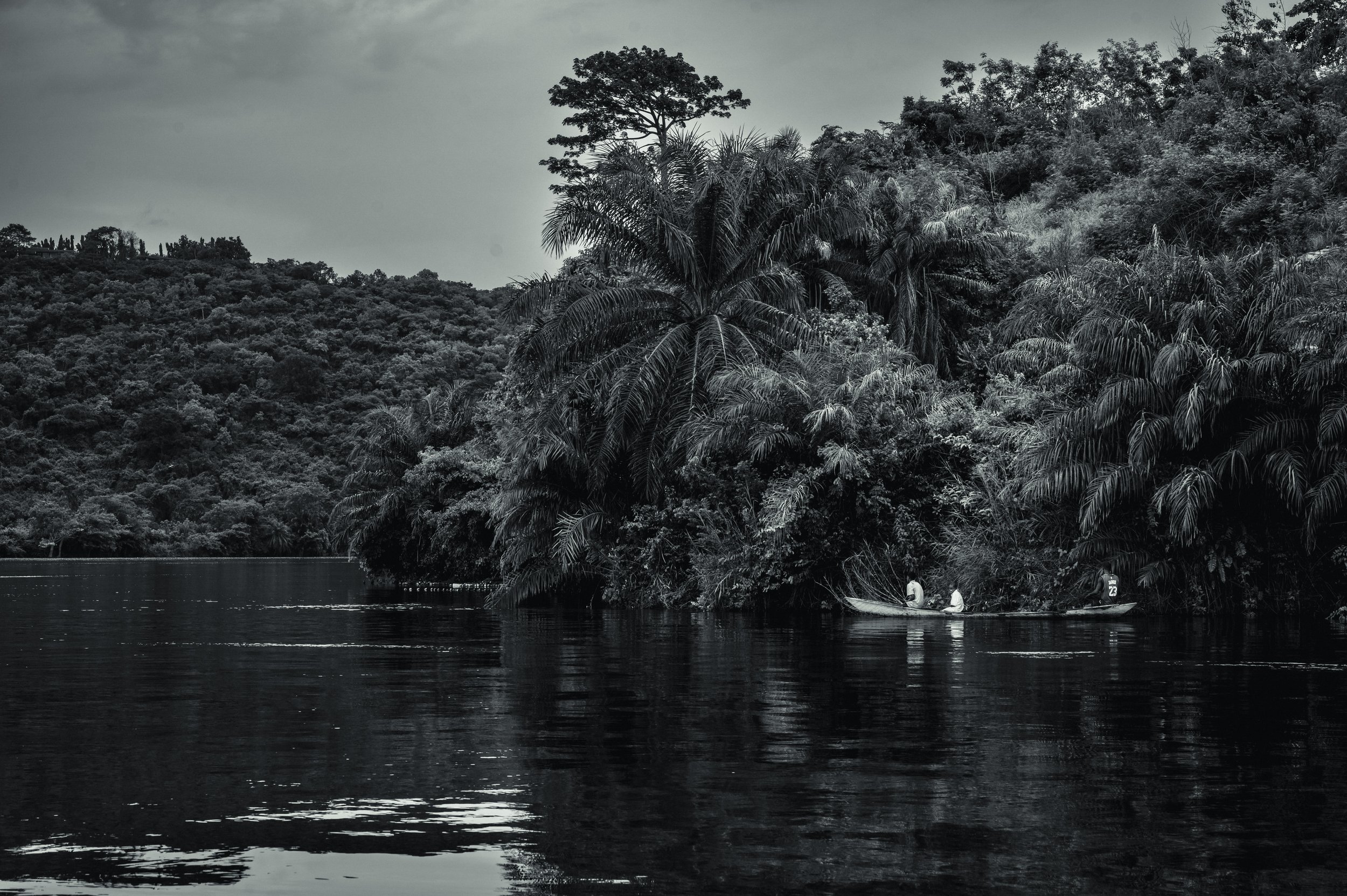 Three young boys paddle around the Volta Lake fishing for Tilapia.