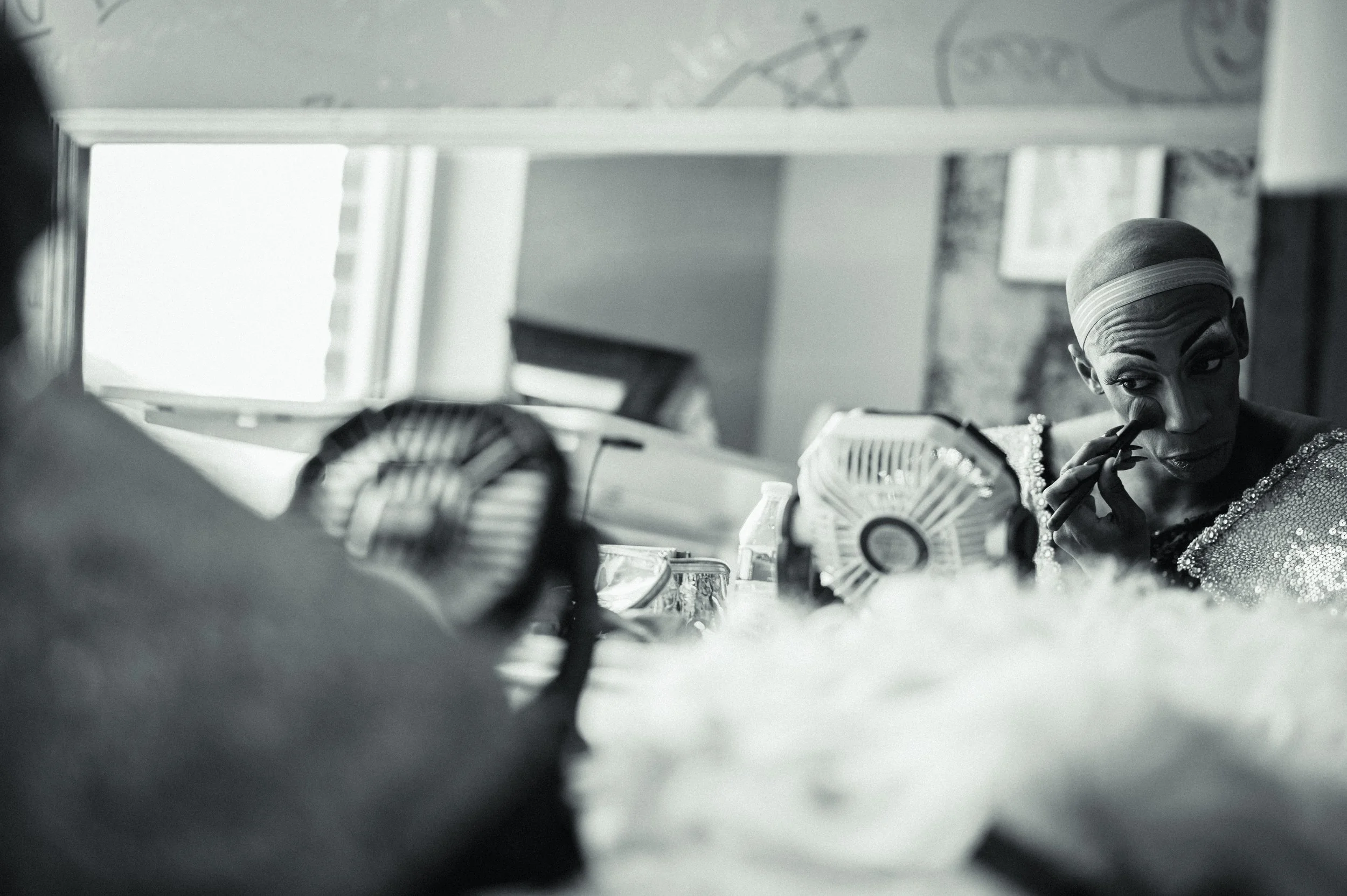 Emerald Envy removes makeup after performing Beyonce at the Harrisonburg Pride Festival.