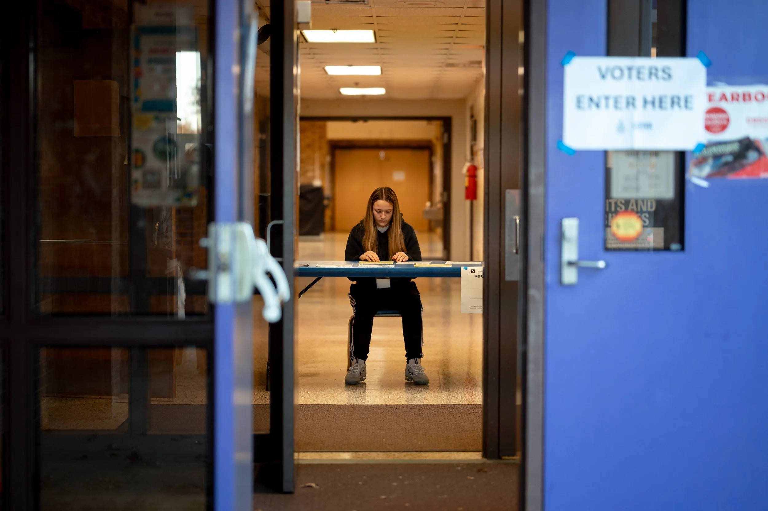 Volunteers assist voters with check-in, registration and ballots at Rocktown High School during Virginia’s election on Tuesday in Harrisonburg, Va. October 4, 2025