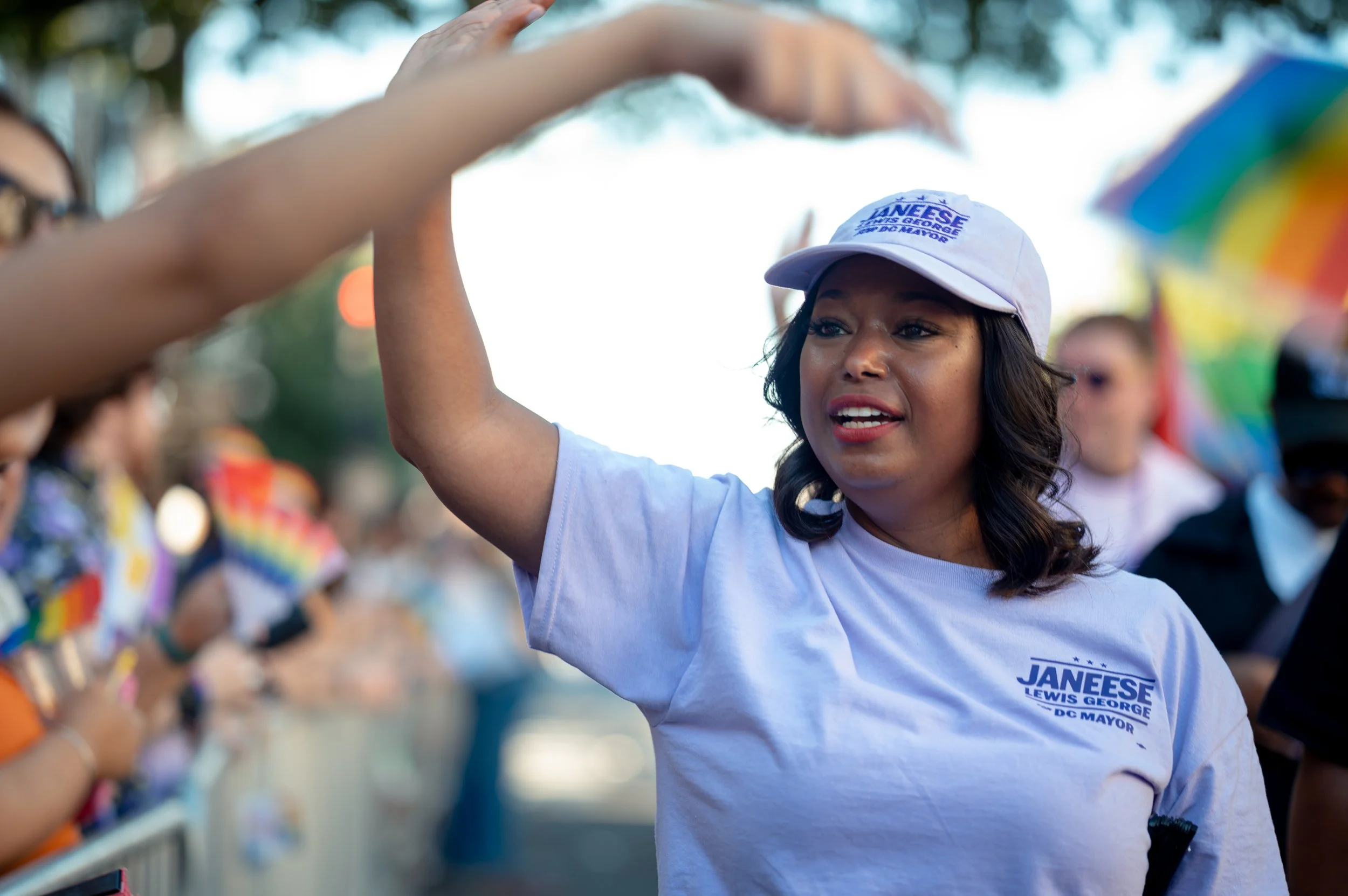 Daneese Lewis George greets attendees during the Capital Pride Parade in Washington, D.C., high-fiving spectators along the route.