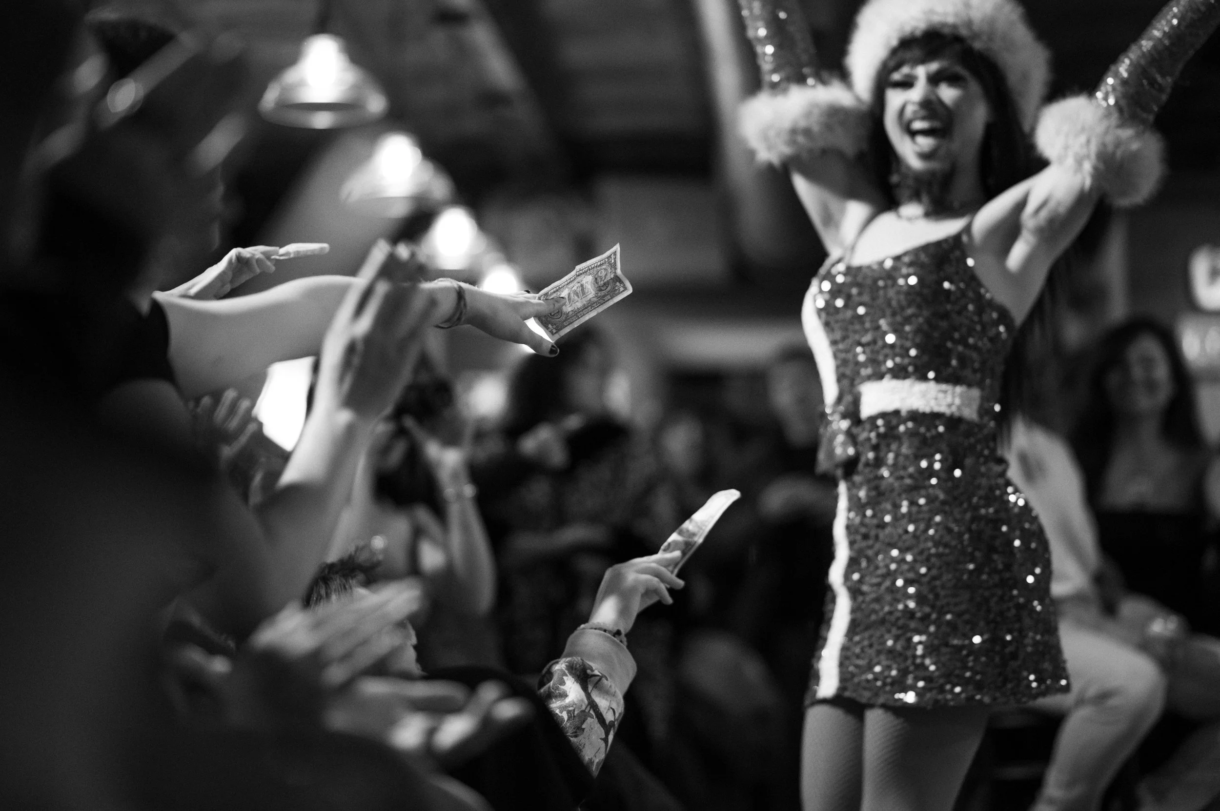 Shenandoah sings Feliz Navidad at a Christmas Drag show twice in a row. The audience breaks into tips and laughter.