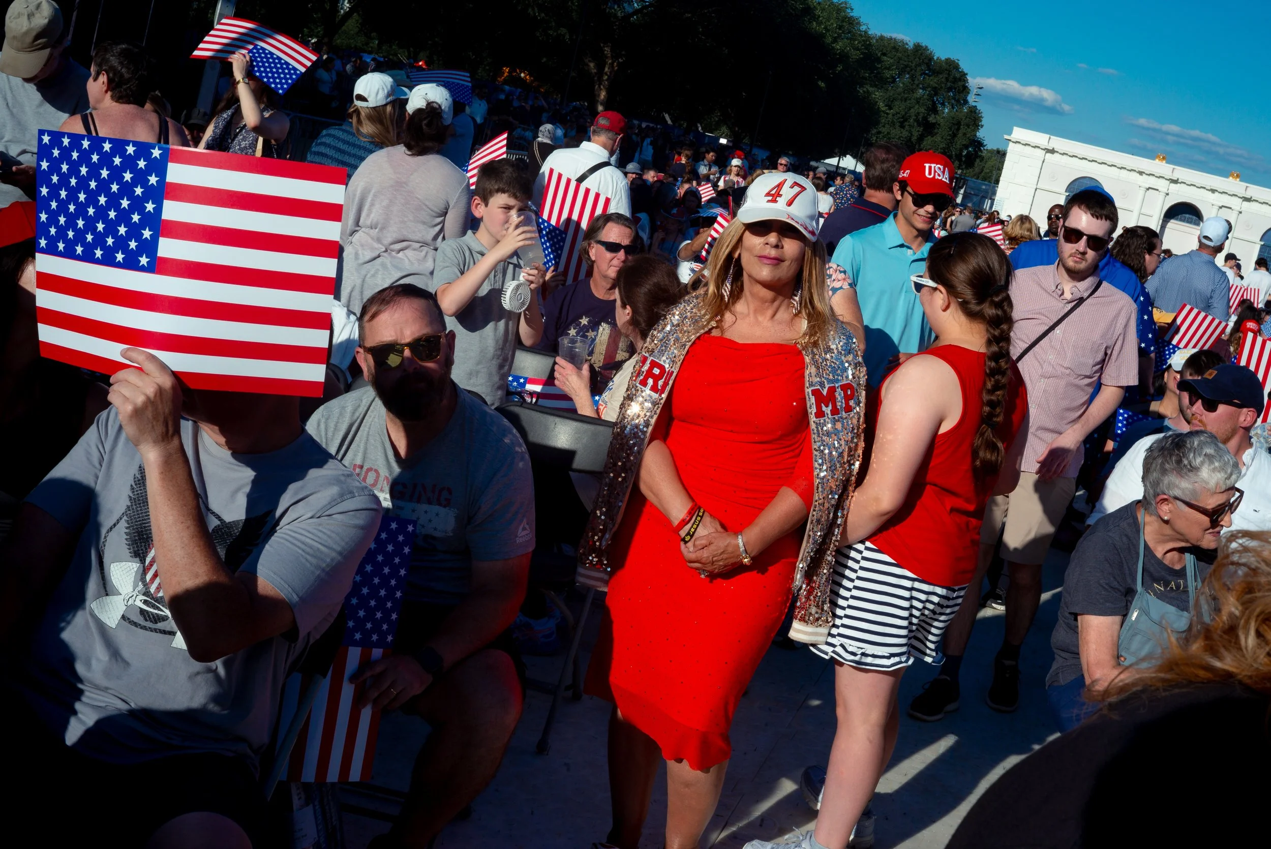 Attendees arrive wearing MAGA apparel and clothing decorated with American flags during the Great American State Fair kickoff event in Des Moines, Iowa, on June 24, 2026.