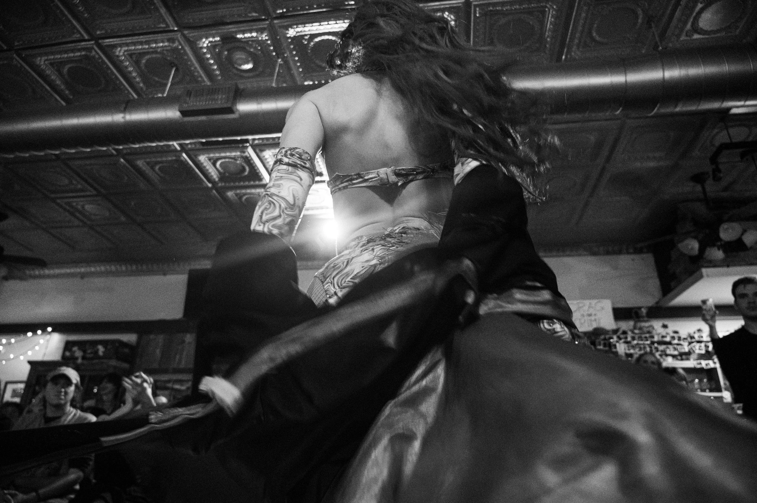 Climaxxx, in a dress she made herself, spins around and lip-syncs a Christmas son.