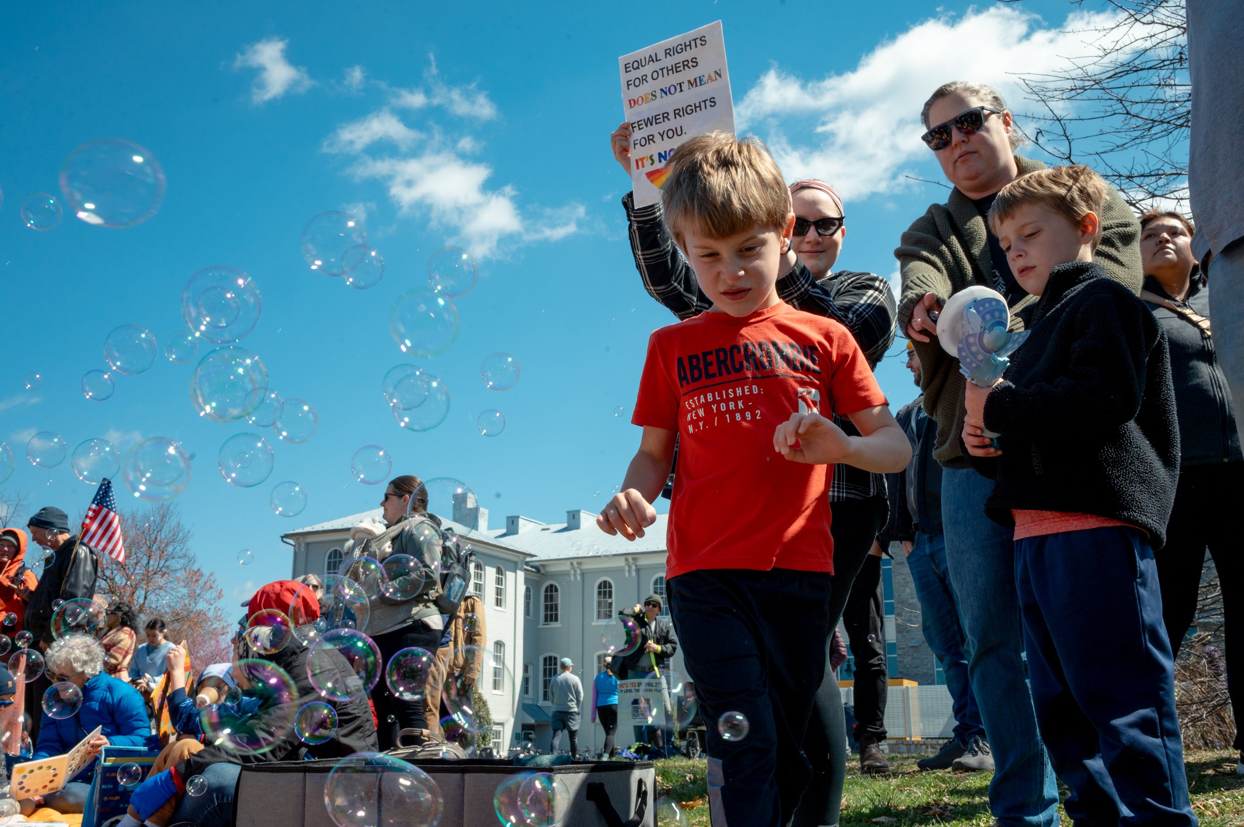 A family brings a bubble maker to entertain young children at the protest. 