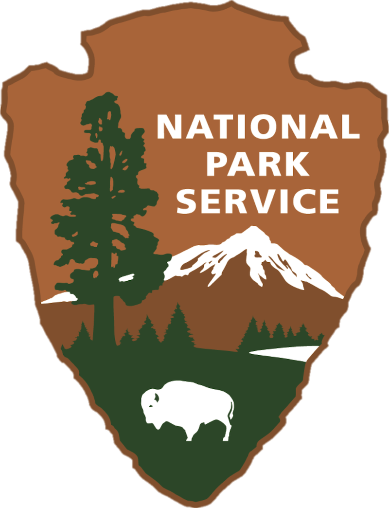 A National Park Service badge featuring a mountain, a pine tree, and a bison.