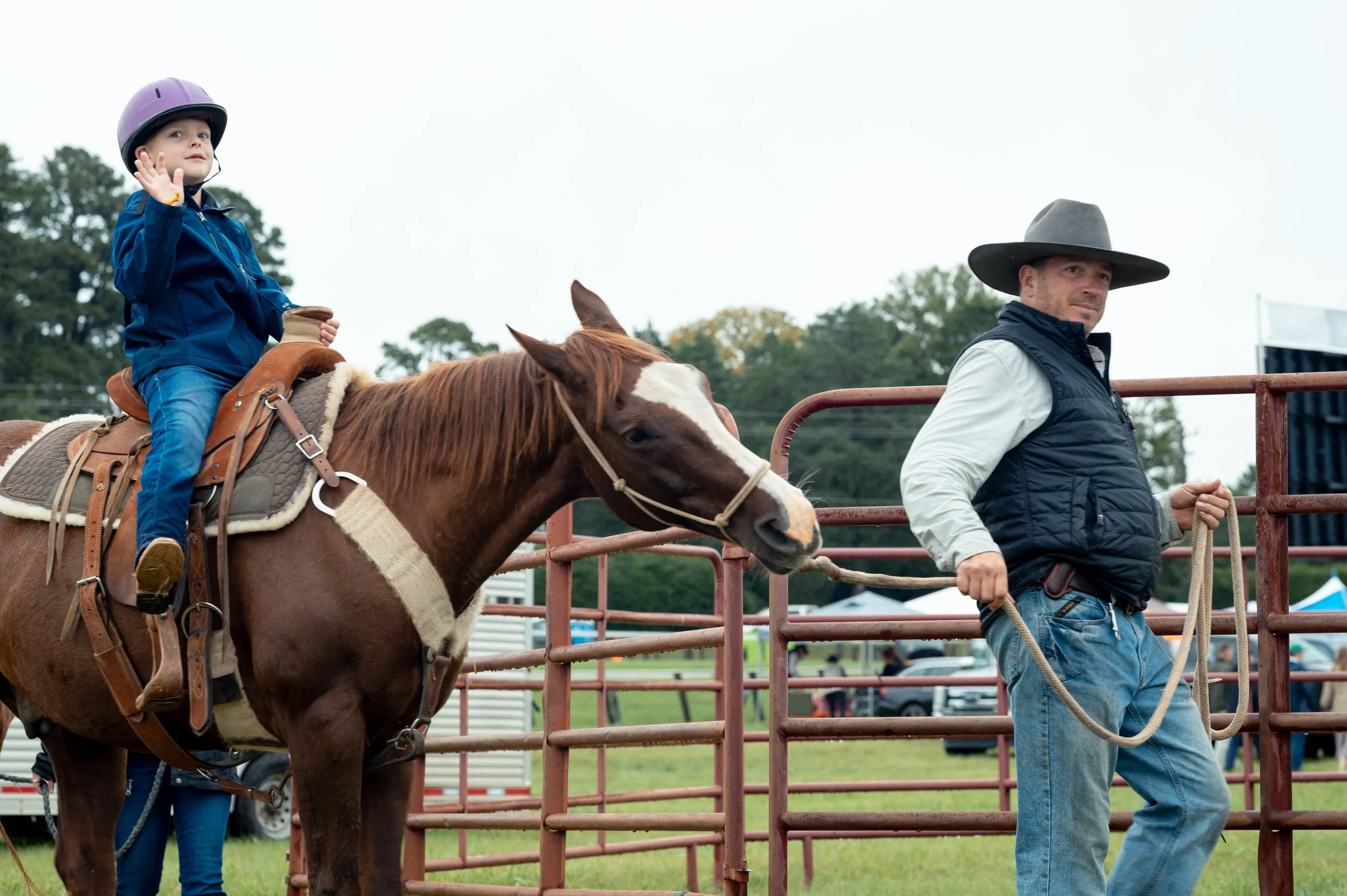 Watson, 4, rides a horse along a path near the children's tent during.