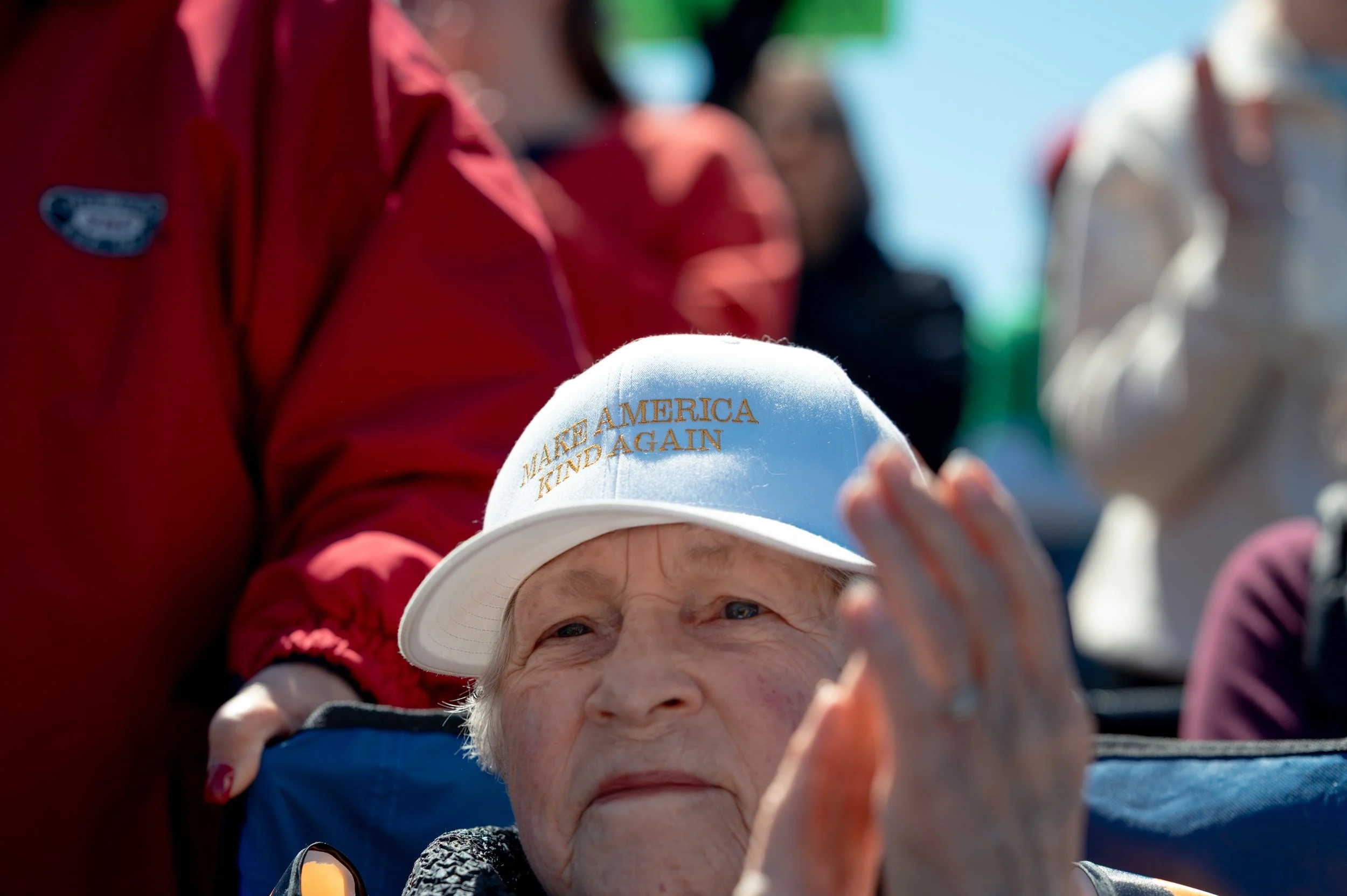 A woman wears a modified MAGA hat to the protest. 