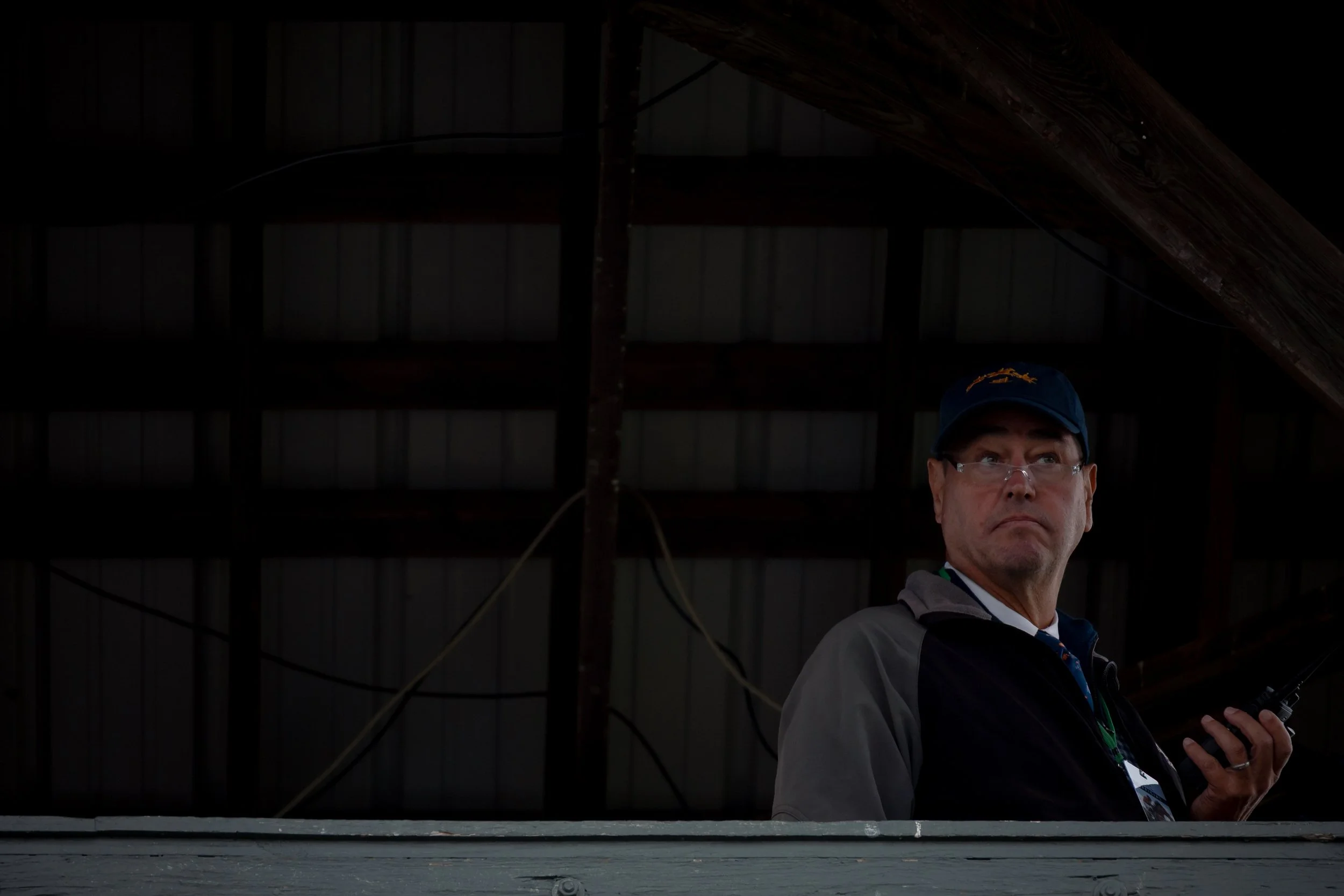 The announcer watches the races from the observation tower at Foxfield Races in Charlottesville, Va.
