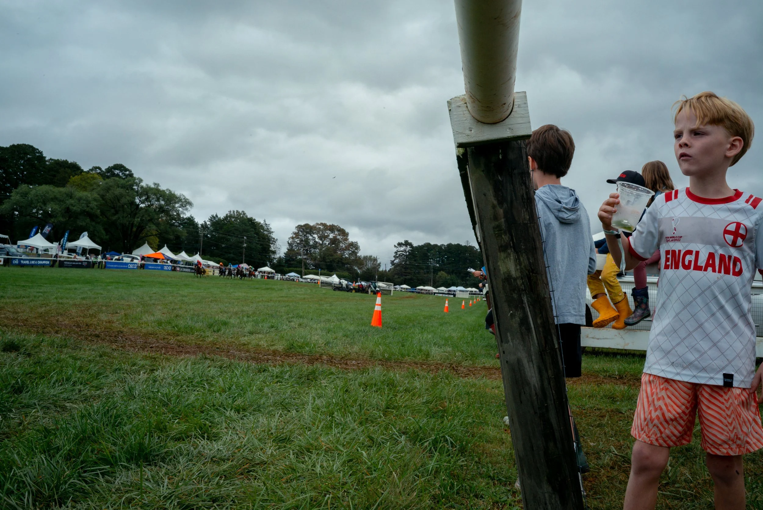 Tommy, 6, watches a race with his family from beneath the observation tower during the Foxfield Fall Races.