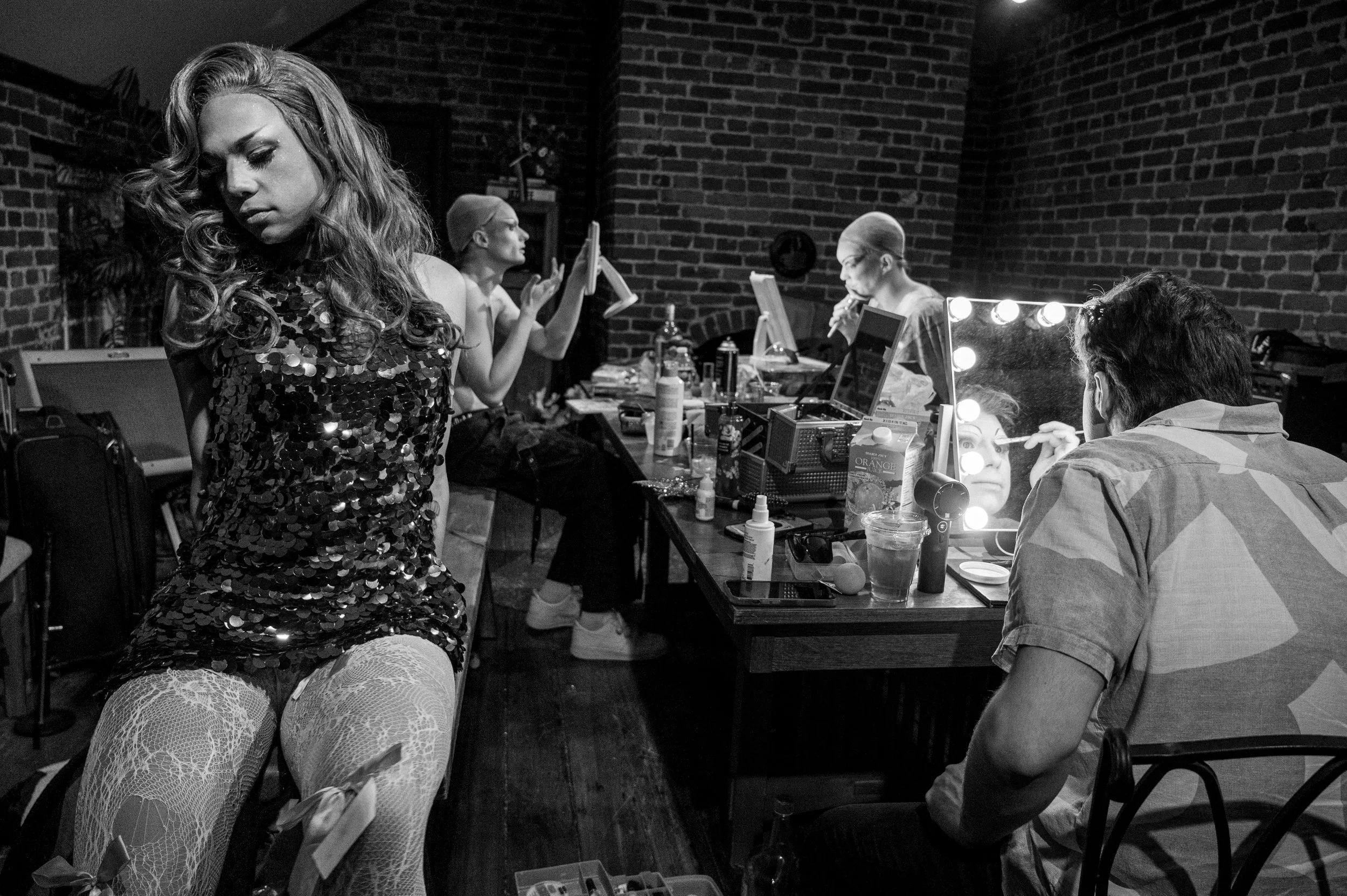 Tijuana, who works full time as a doctor’s assistant, prepares for a drag performance alongside other performers just days before Christmas. Backstage, performers adjusted makeup and costumes while bracing themselves ahead of the late-night show.