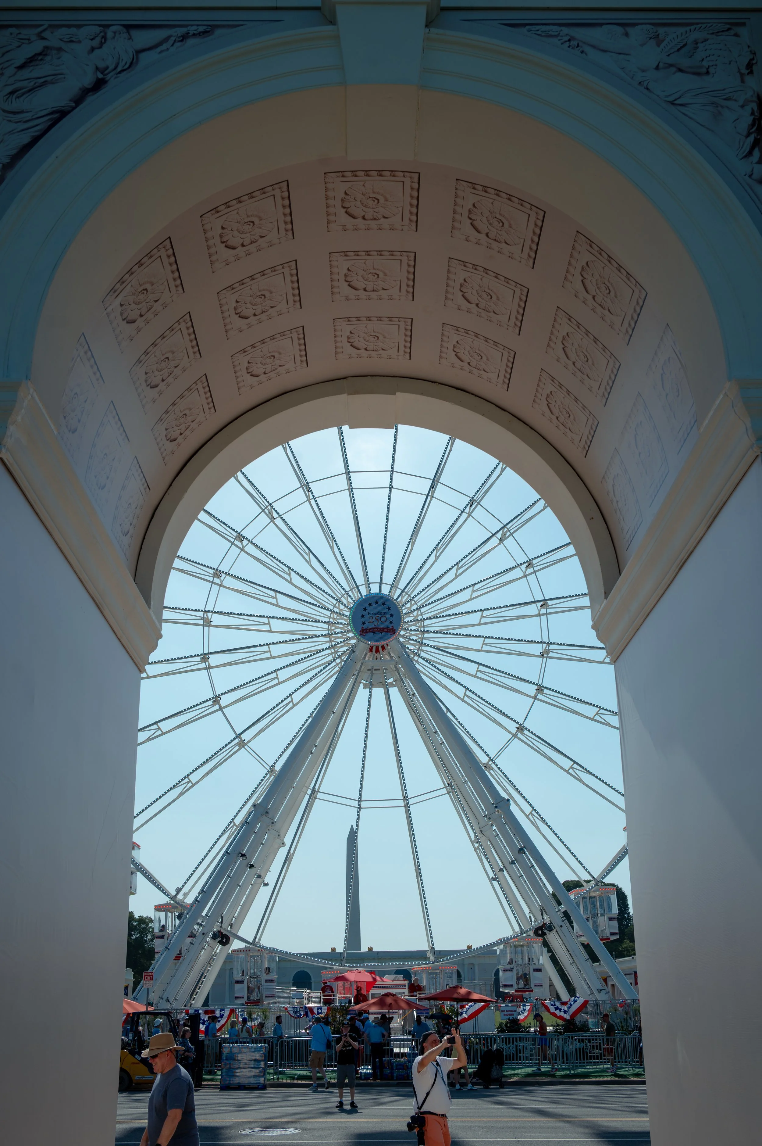 A replica of President Donald Trump's proposed triumphal arch stood at the entrance to the Great American State Fair on the National Mall alongside the 110-foot Freedom Wheel on July 2, 2026. The two structures served as the fair's most recognizable 