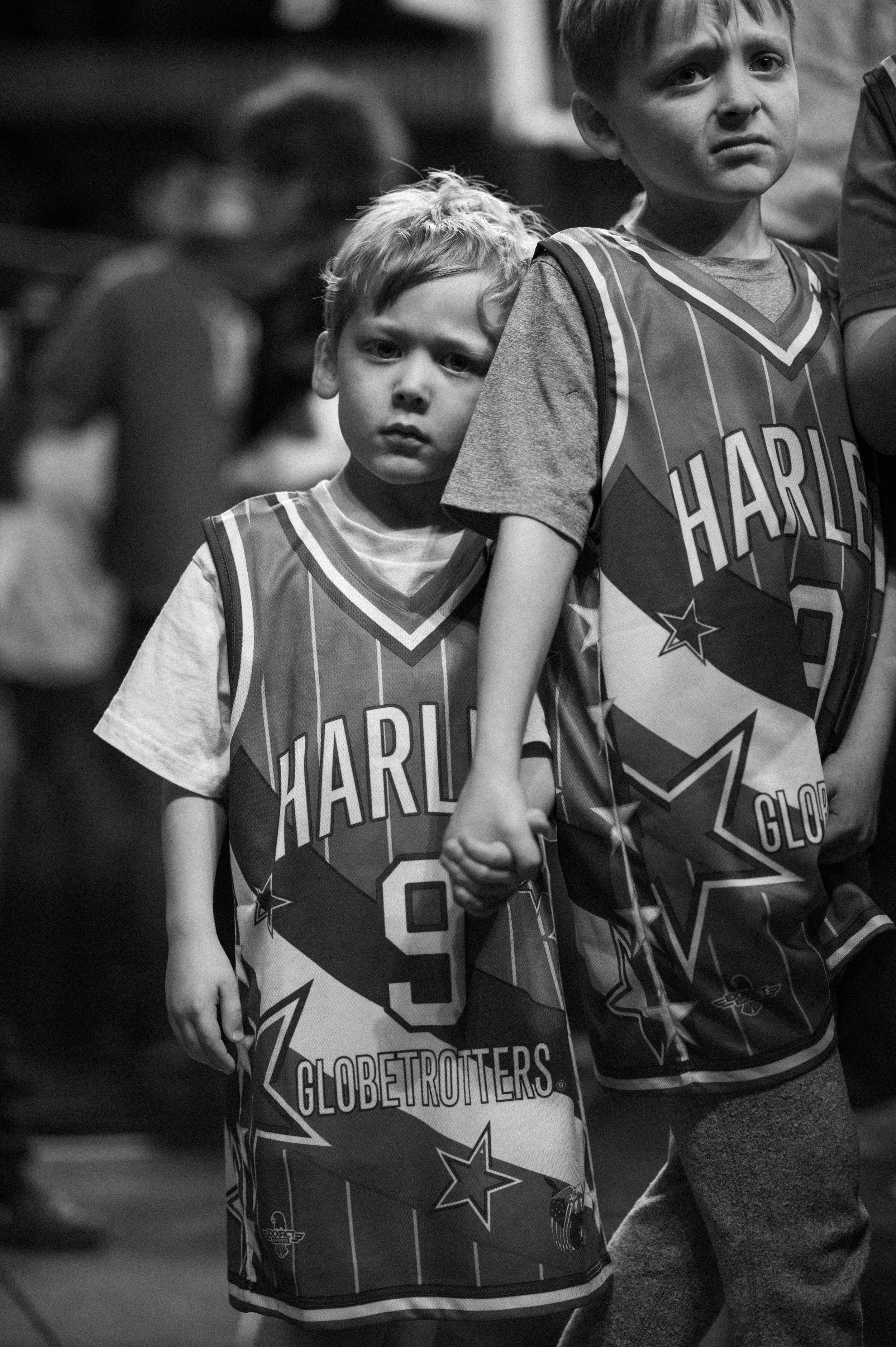 Two young boys hold hands at a Harlem Globe Trotters game at AUBC. 