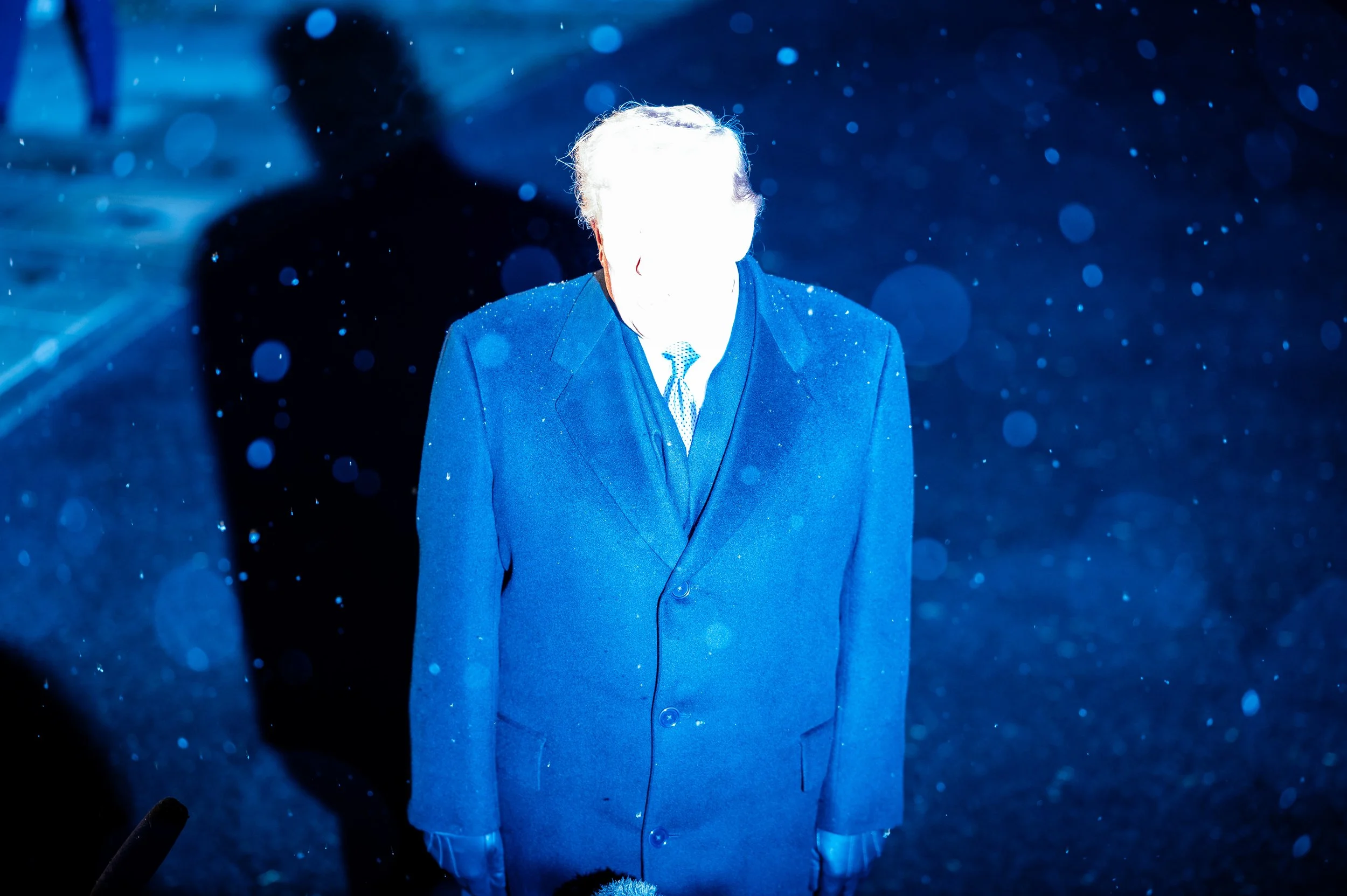 A photographers flash hits President Donald Trump in the snow on the South Lawn. February 7, 2026.