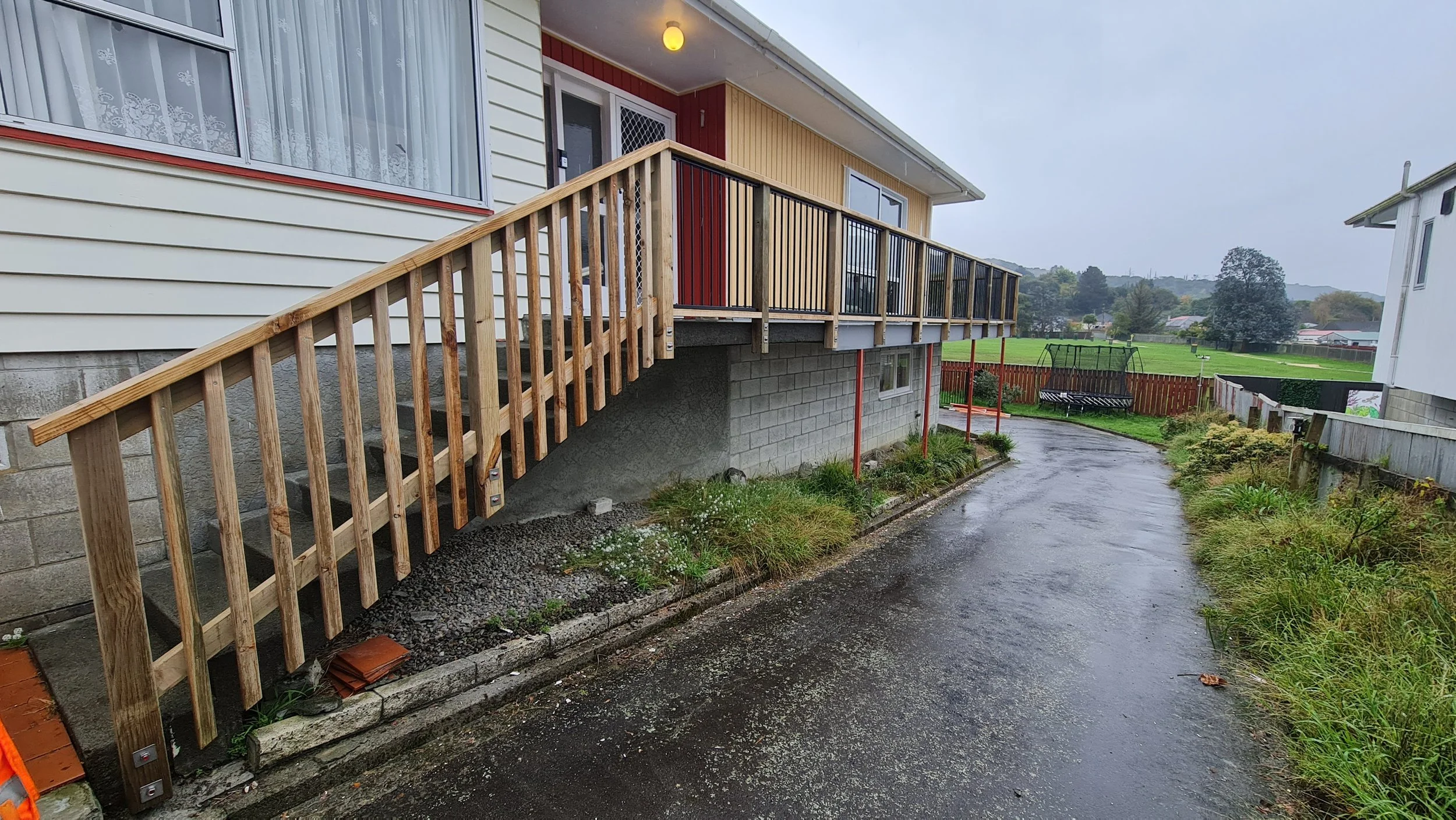 new deck membrane with new balustrade and reclad with vertical weatherboard