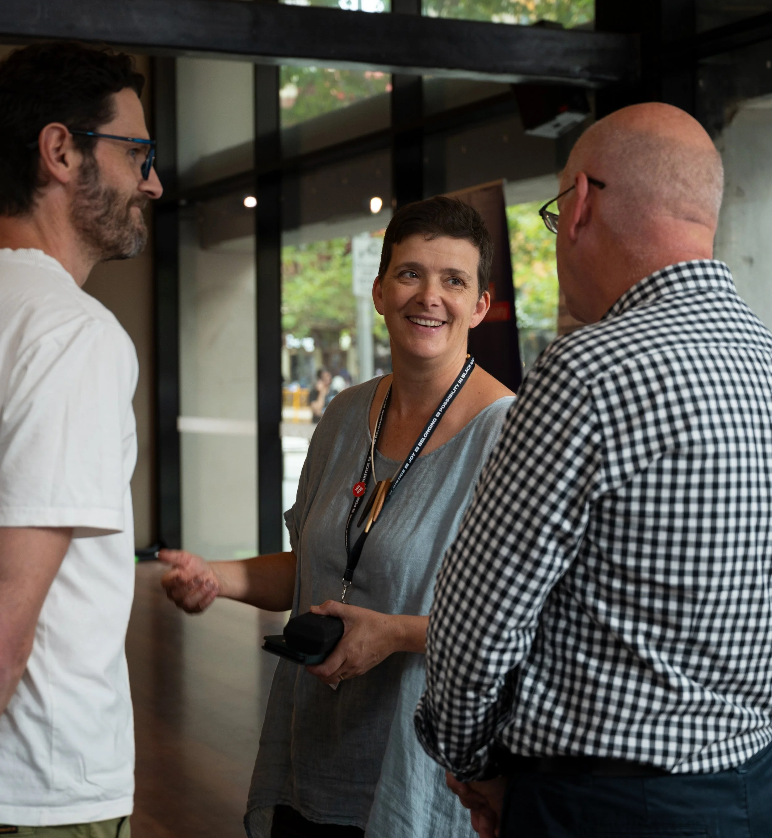 Three RMIT Staff in discussion at an end of year awards event.