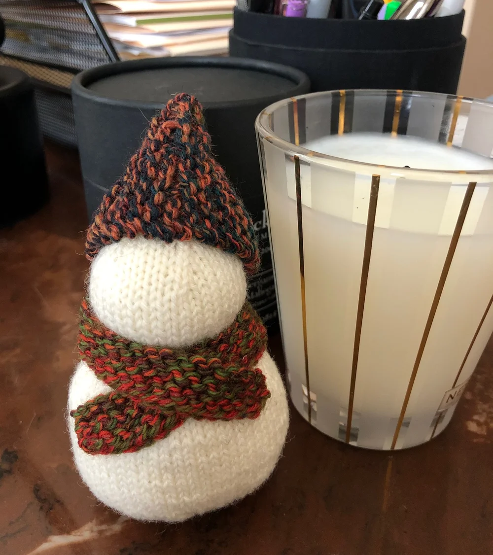 Snow person sitting cozy on my desk
