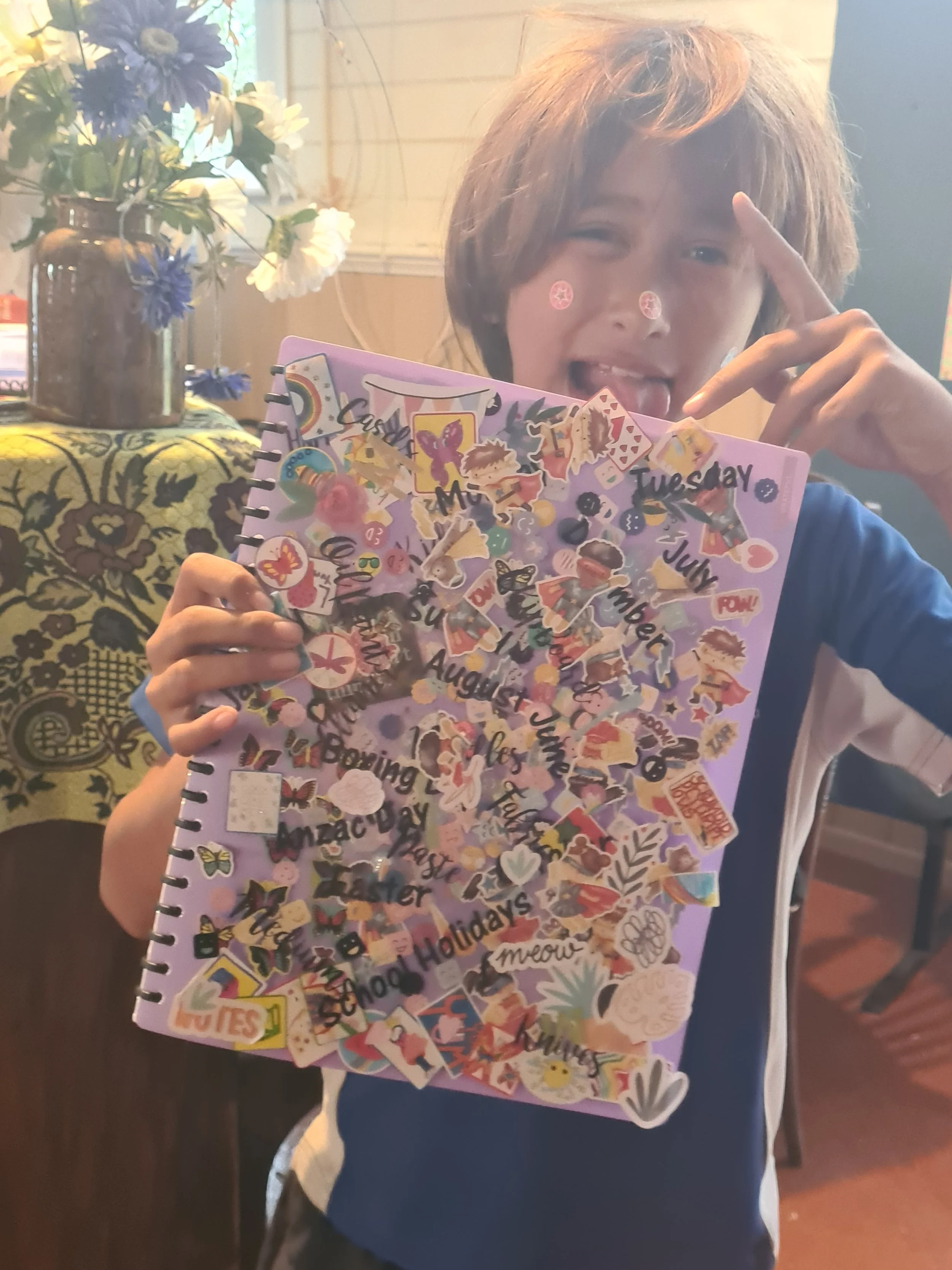 One of our tamariki -- freshly finished decorating his display book for all the design mahi, entrepreneur planning and literacy activities we do