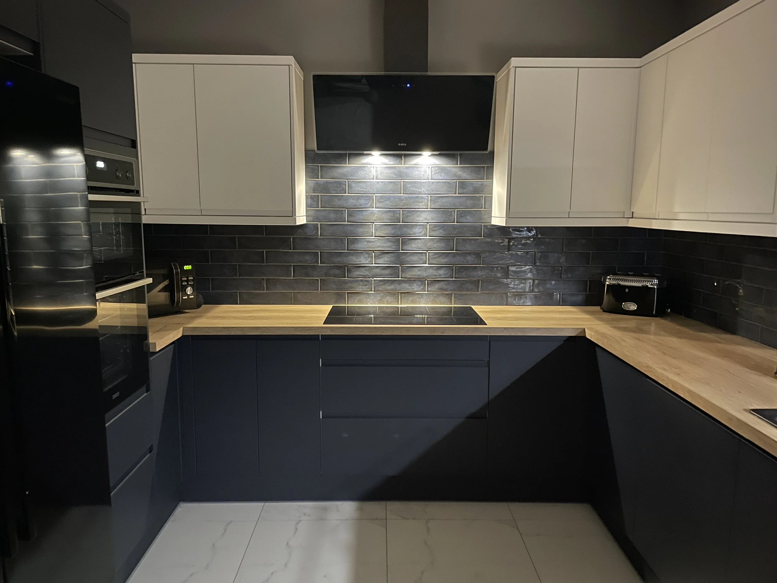 Midnight blue kitchen with wooden worktops.JPG