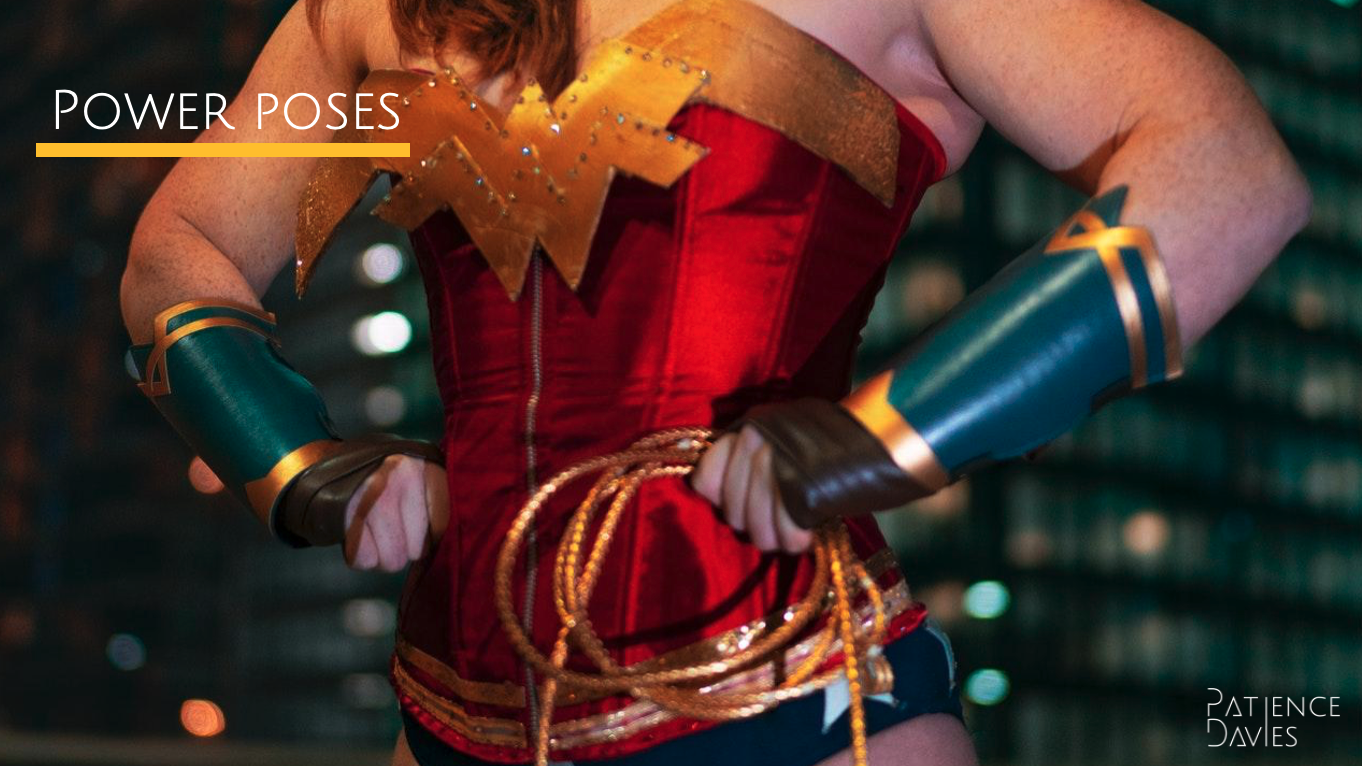 A woman stands with her hands on her hips in a Wonder Woman costume