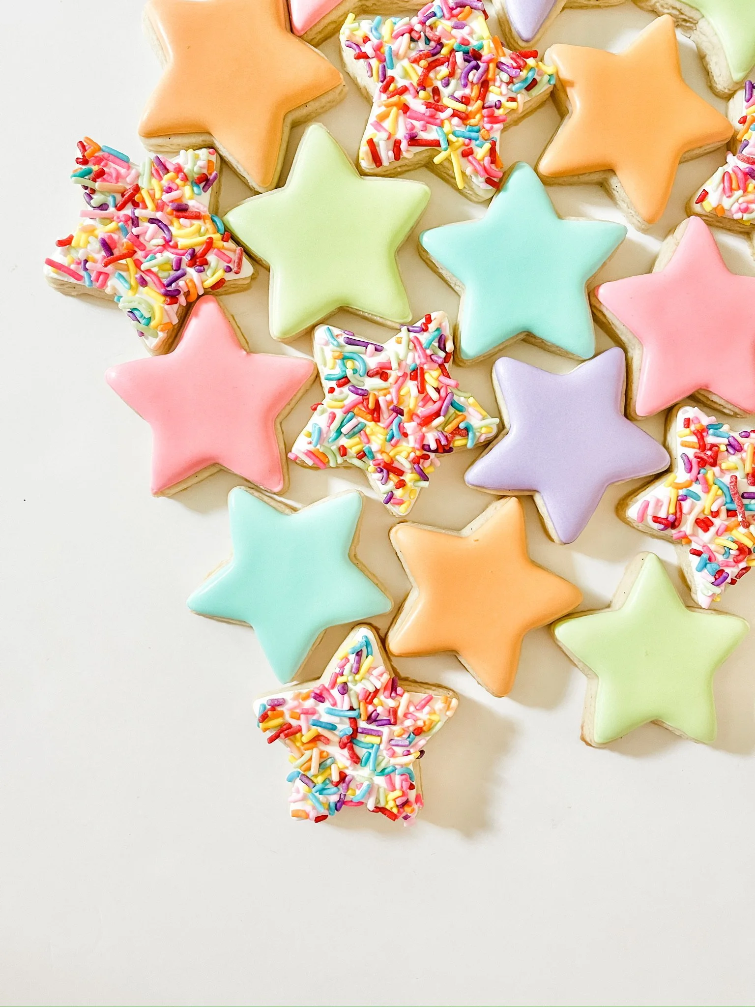 6 mini iced sugar cookies. Choose from pink bows, sprinkle stars, or lavender hearts.