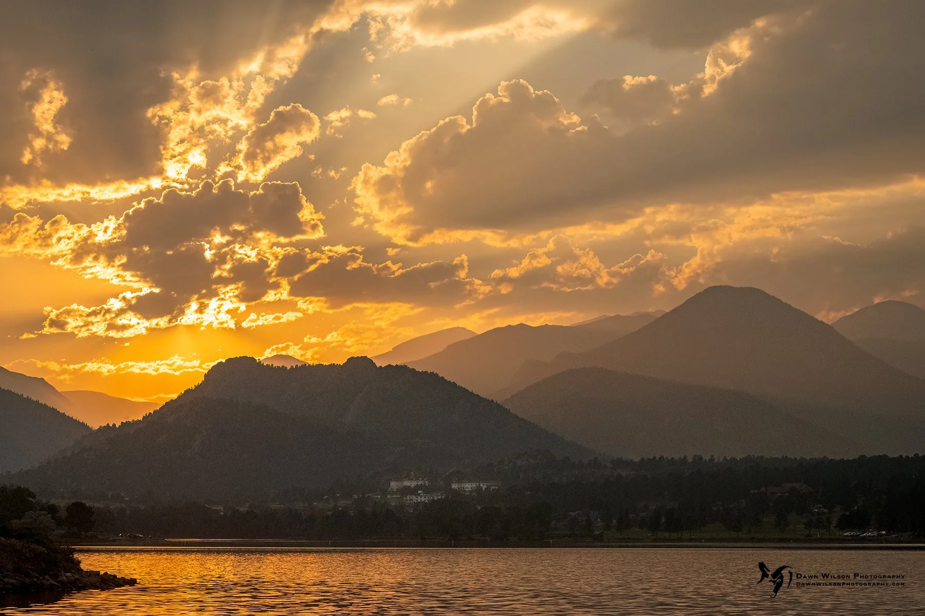 A dramatic sunset over Lake Estes after a summer storm in Estes Park, Colorado.