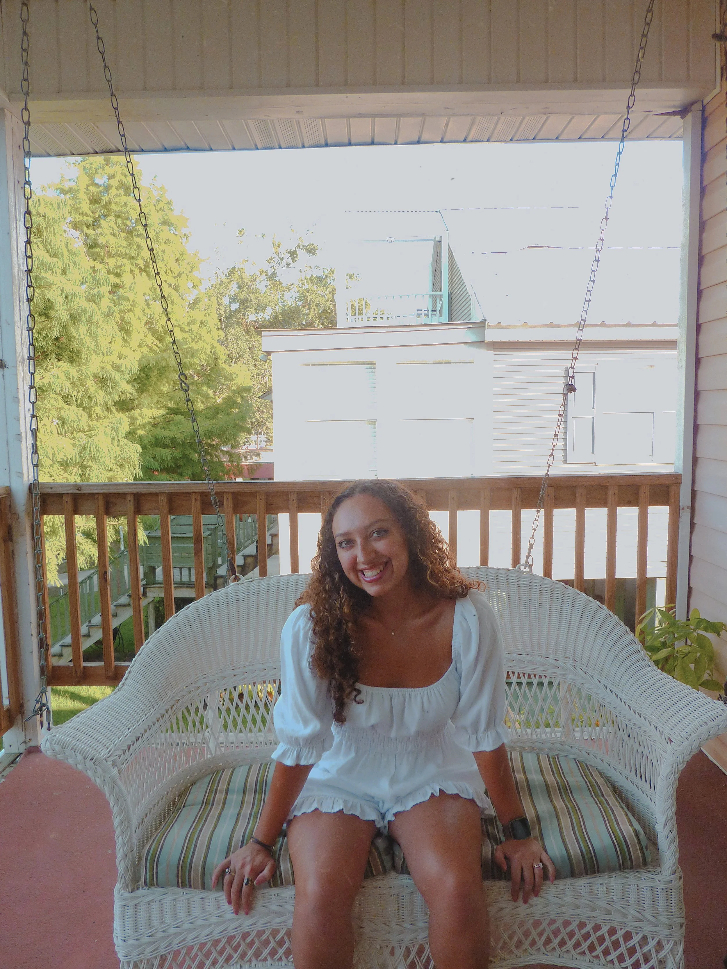 Senea Bryant, artist, sitting on a bench