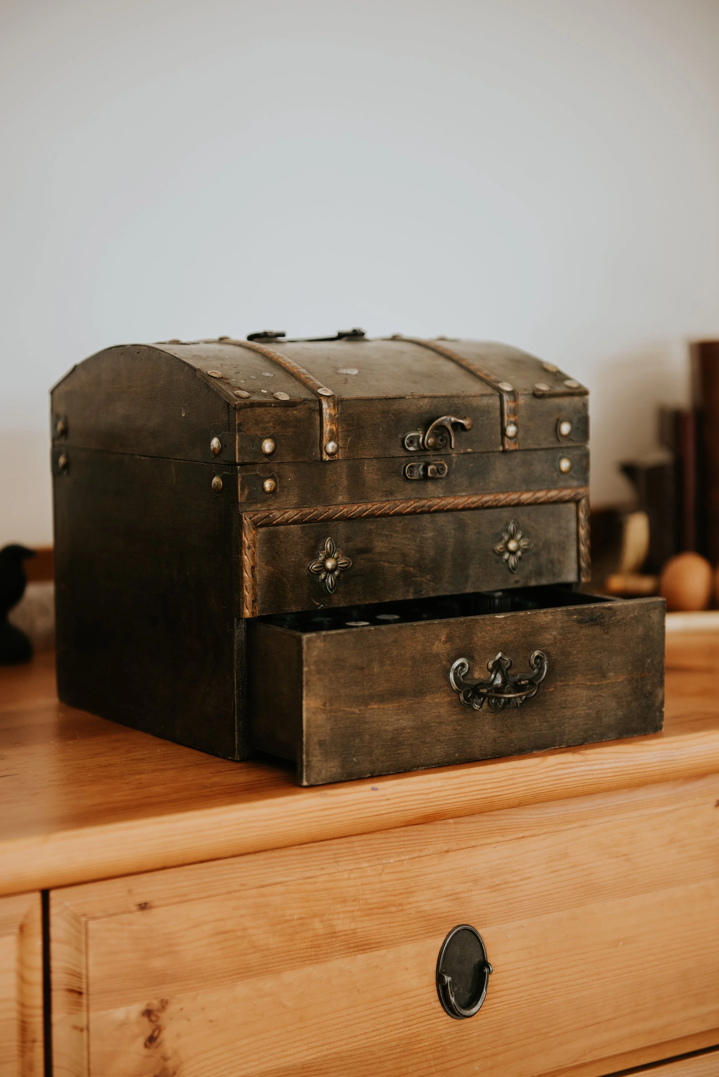 An old wooden chest with the bottom draw slightly open.